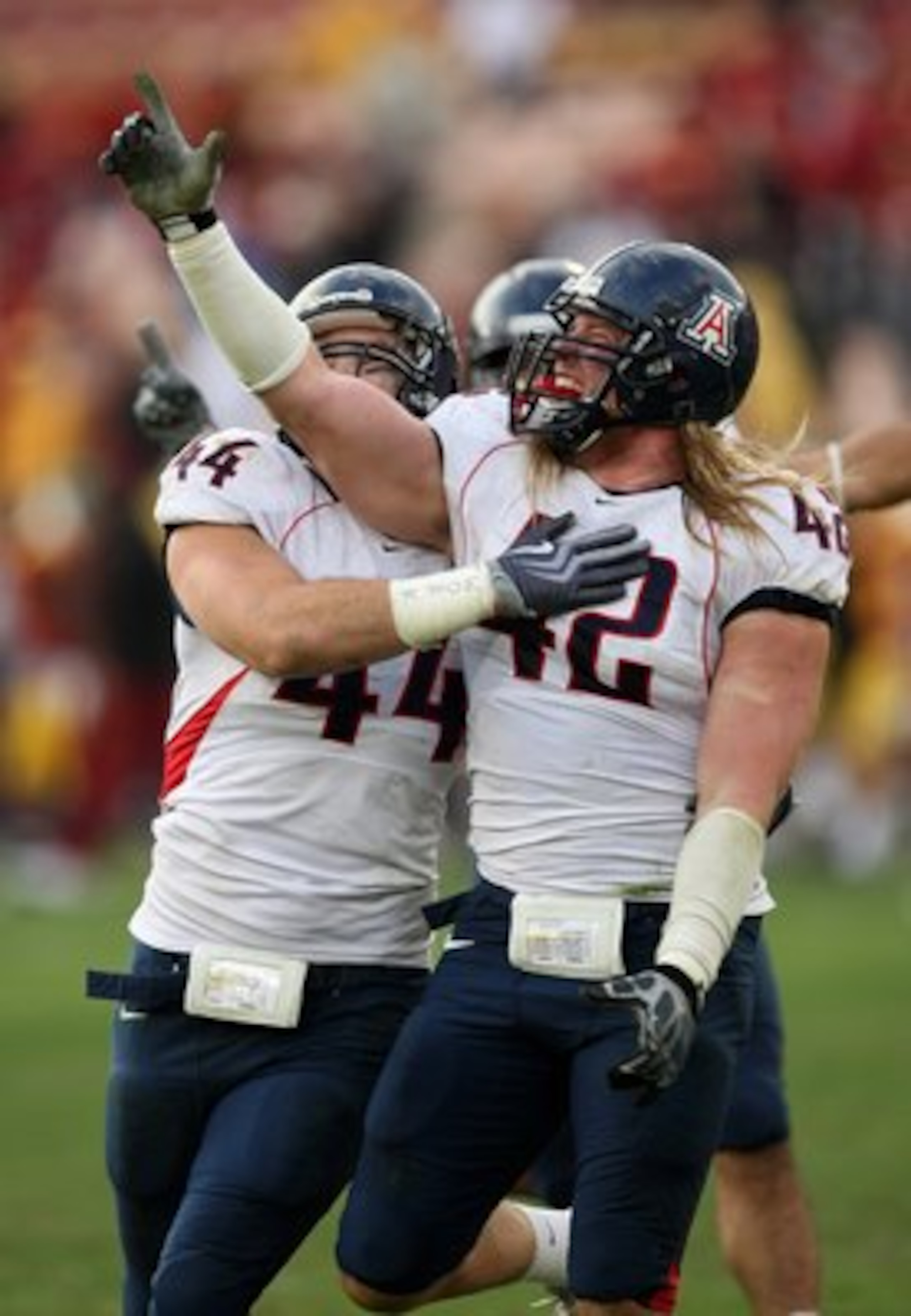 LOS ANGELES, CA - DECEMBER 05: Defensive ends Brooks Reed #42 and Ricky Elmore #44 of the Arizona Wildcats celebrate after stopping the USC Trojans on the final play on December 5, 2009 at the Los Angeles Coliseum in Los Angeles, California. Arizona won LOS ANGELES, CA - DECEMBER 05: Defensive ends Brooks Reed #42 and Ricky Elmore #44 of the Arizona Wildcats celebrate after stopping the USC Trojans on the final play on December 5, 2009 at the Los Angeles Coliseum in Los Angeles, California. Arizona won