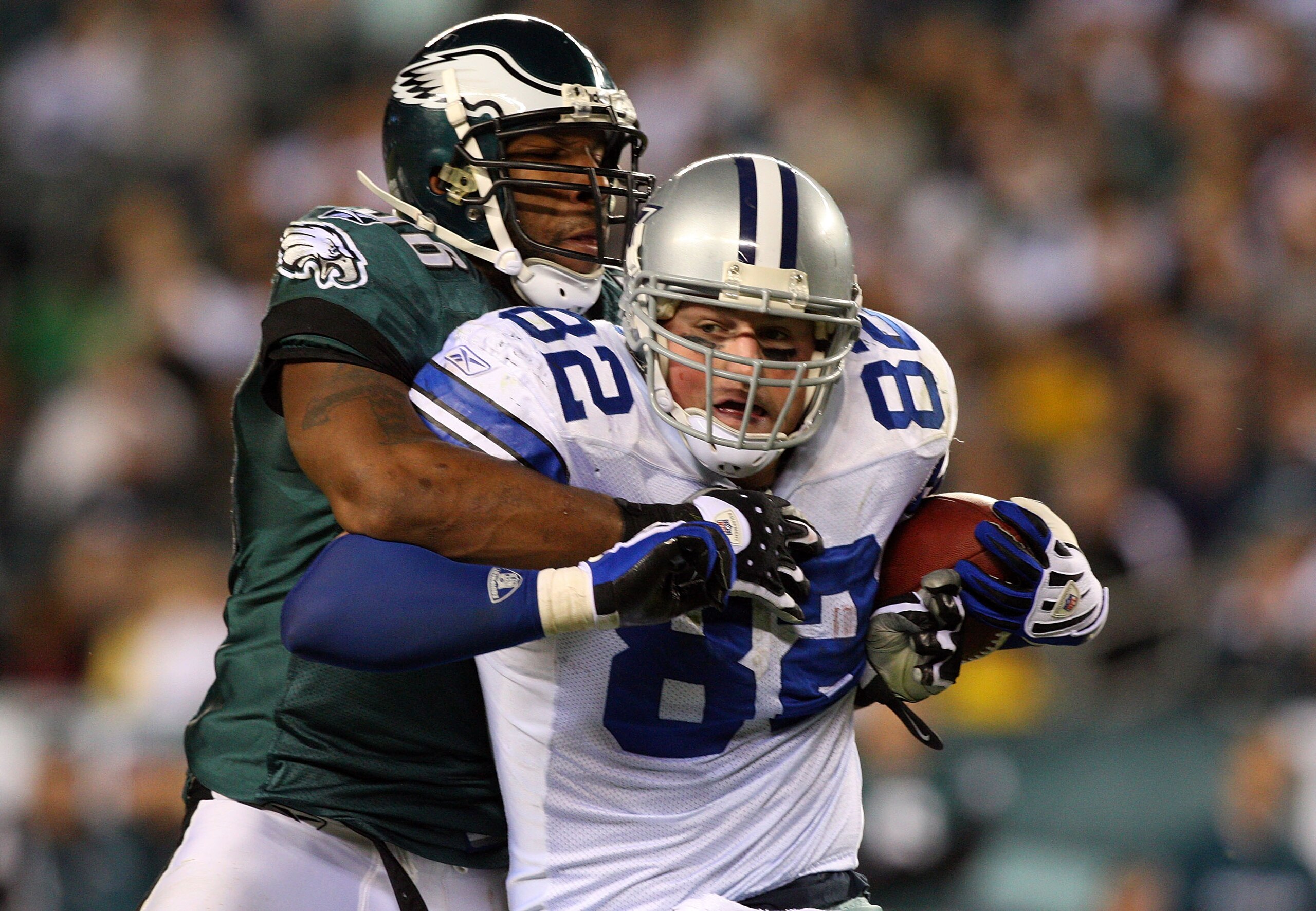PHILADELPHIA - DECEMBER 28:  Omar Gaither #96 of the Philadelphia Eagles tackles Jason Witten #82 of the Dallas Cowboys on December 28, 2008 at Lincoln Financial Field in Philadelphia, Pennsylvania. The Eagles defeated the Cowboys 44-6.  (Photo by Jim McI