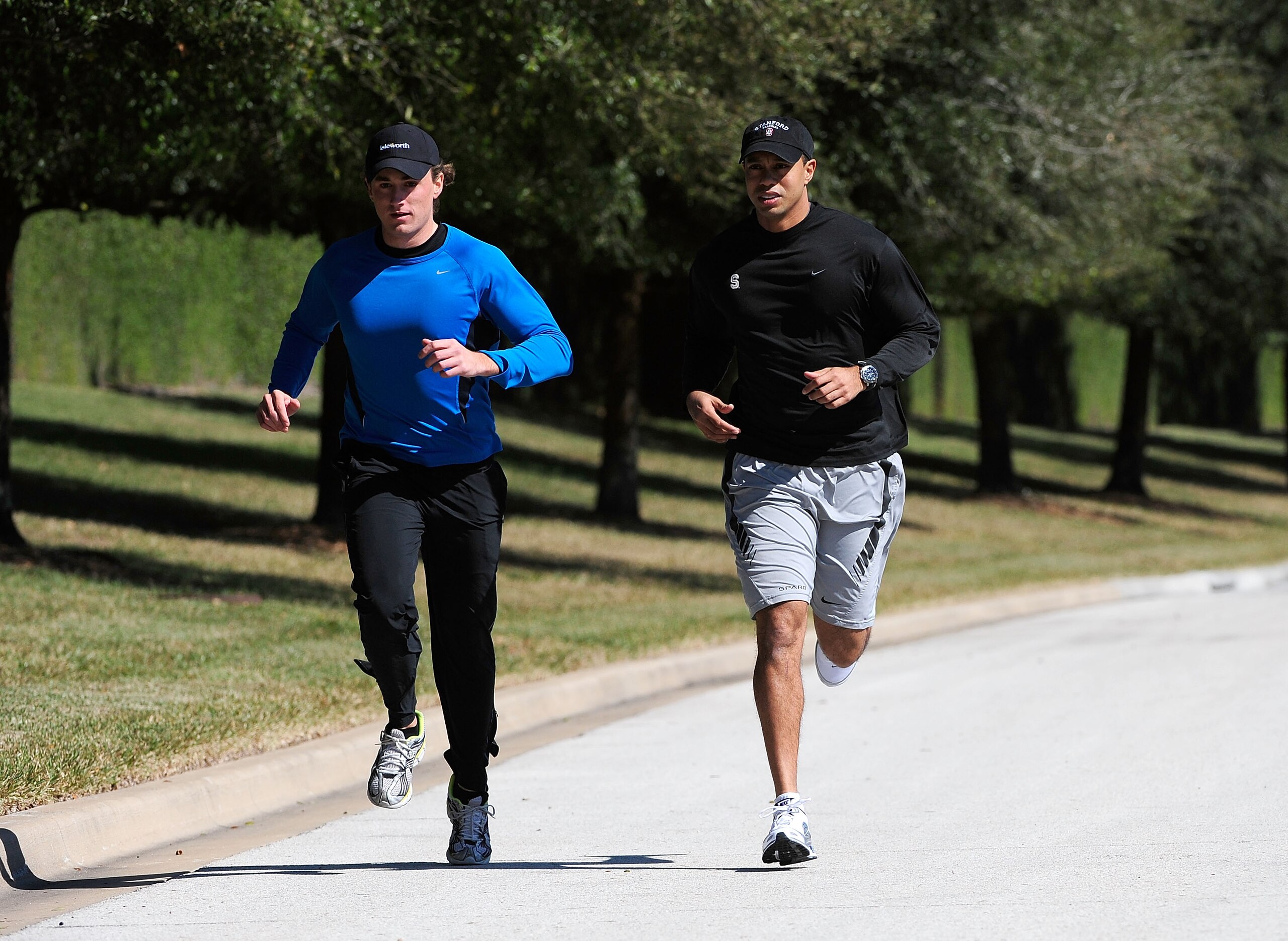 ORLANDO, FL - FEBRUARY 17:  Tiger Woods (R) jogs with an unidentified friend near his home on February 17, 2010 in Orlando, Florida. The PGA Tour has just announced that Tiger Woods will make a statement this Friday morning (February 19, 2010) at their he