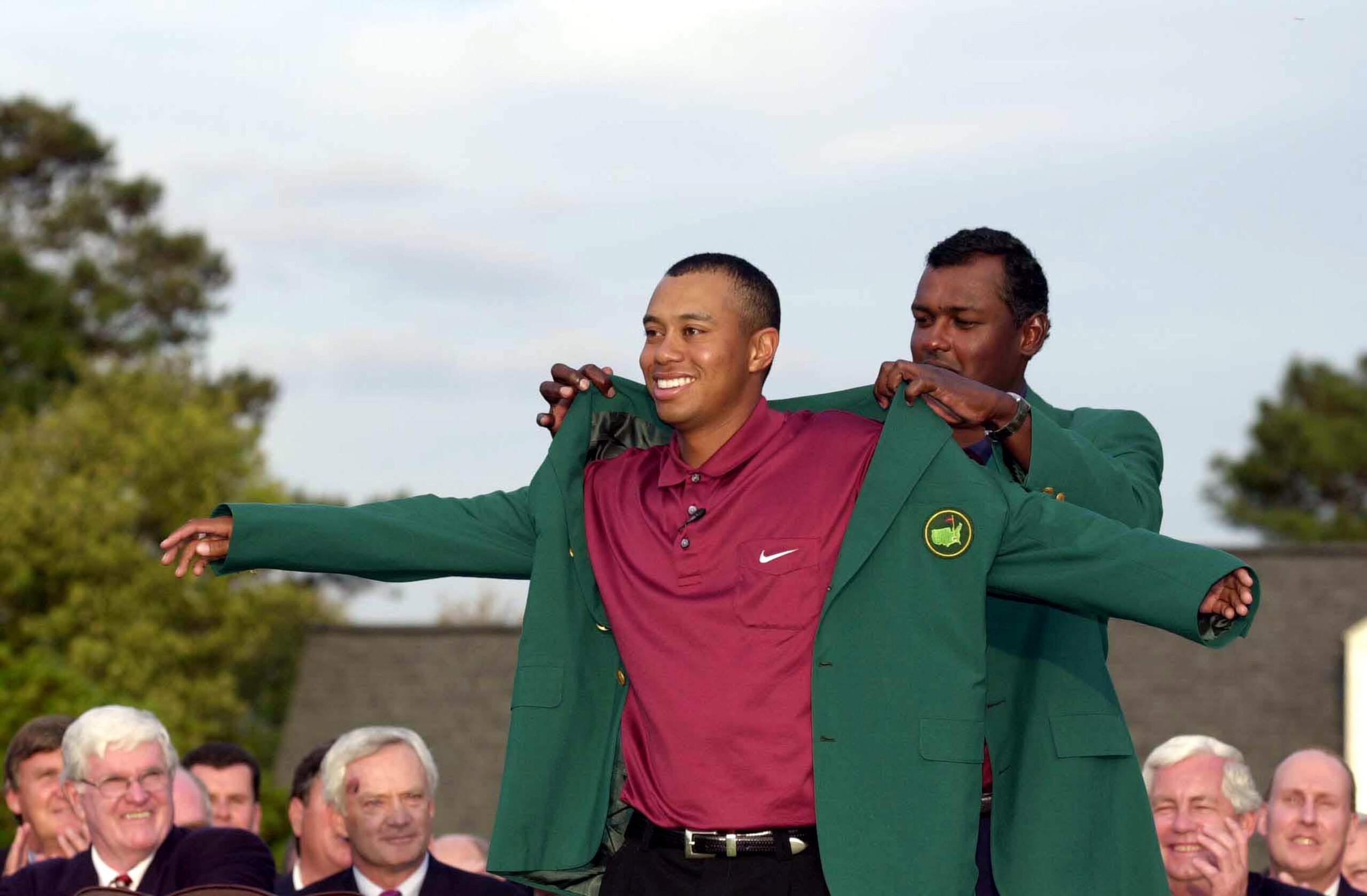 8 Apr 2001:  Tiger Woods of the USA is presented with his second green jacket by defending champion Vijay Singh of Fiji after the final day of the 2001 Masters at the Augusta National Golf Club, Augusta, Georgia, USA. DIGITAL IMAGE Mandatory Credit: Harry