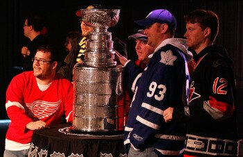 RALEIGH, NC - JANUARY 28:  Hockey fans pose with the Stanley Cup inside the NHL Fan Fair part of 2011 NHL All-Star Weekend at the Raleigh Convention Center on January 28, 2011 in Raleigh, North Carolina.  (Photo by Kevin C. Cox/Getty Images)