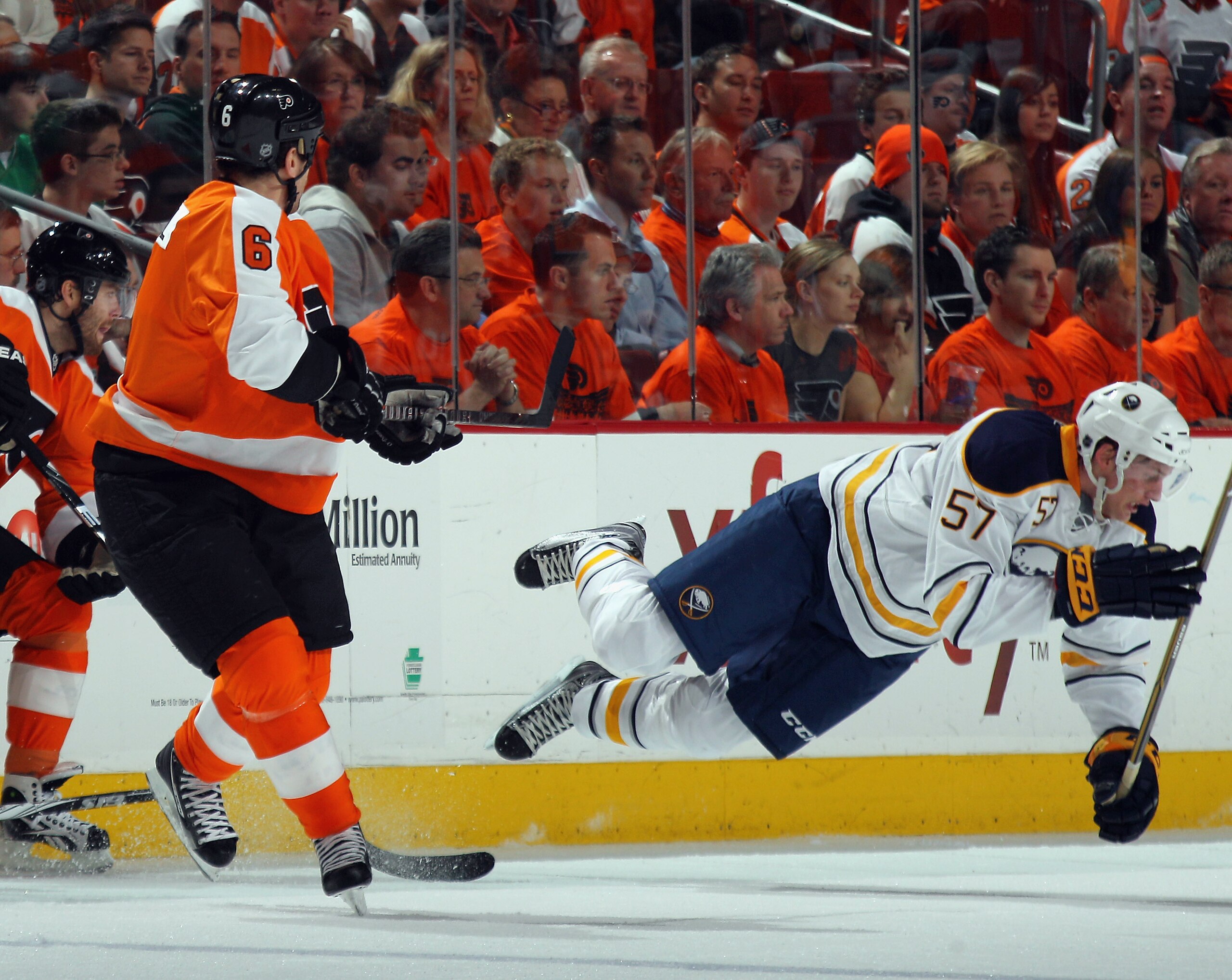 PHILADELPHIA, PA - APRIL 14: Tyler Myers #57 of the Buffalo Sabres is tripped up by Sean O'Donnell #6 of the Philadelphia Flyers in Game One of the Eastern Conference Quarterfinals during the 2011 NHL Stanley Cup Playoffs at Wells Fargo Center on April 14