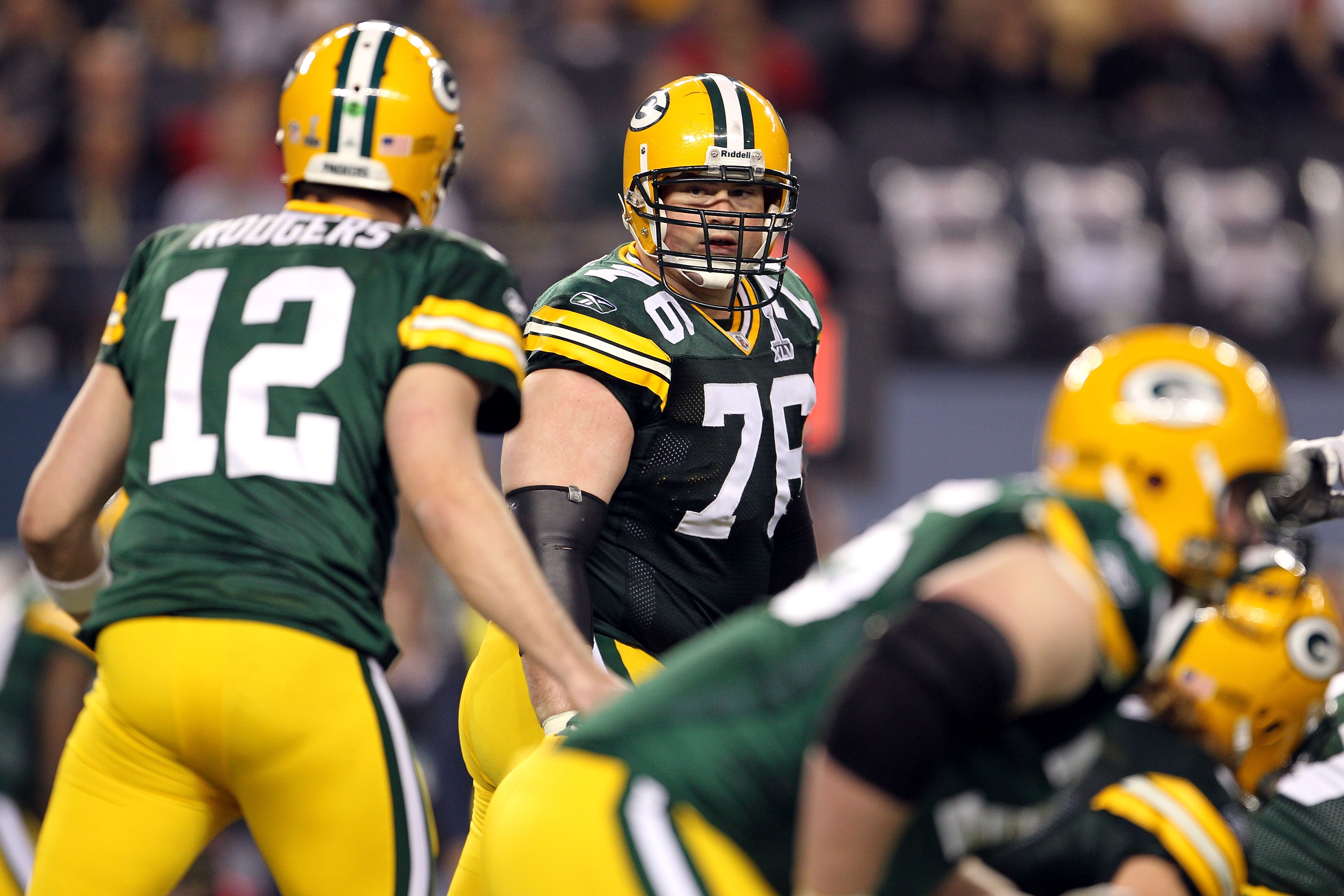 ARLINGTON, TX - FEBRUARY 06:  Chad Clifton #76 of the Green Bay Packers looks back at Aaron Rodgers #12 against the Pittsburgh Steelers during Super Bowl XLV at Cowboys Stadium on February 6, 2011 in Arlington, Texas.  (Photo by Jamie Squire/Getty Images)