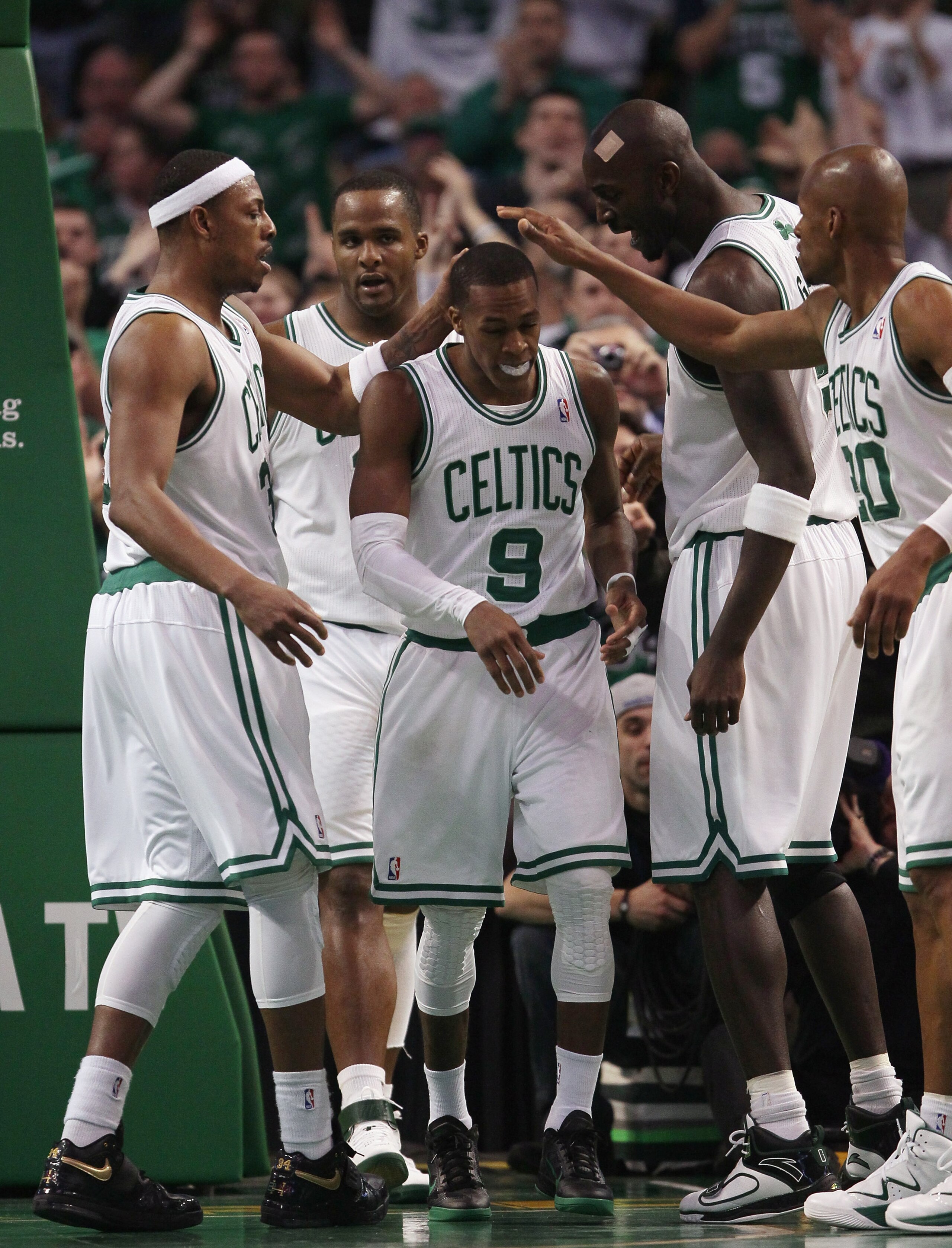 BOSTON, MA - FEBRUARY 06:  Rajon Rondo #9 of the Boston Celtics is congratulated by teammates Paul Pierce #23,Glen Davis #11,Kevin Garnett #5 and Ray Allen #20 after Rondo drew the foul in the second half agianst the Orlando Magic on February 6, 2011 at t