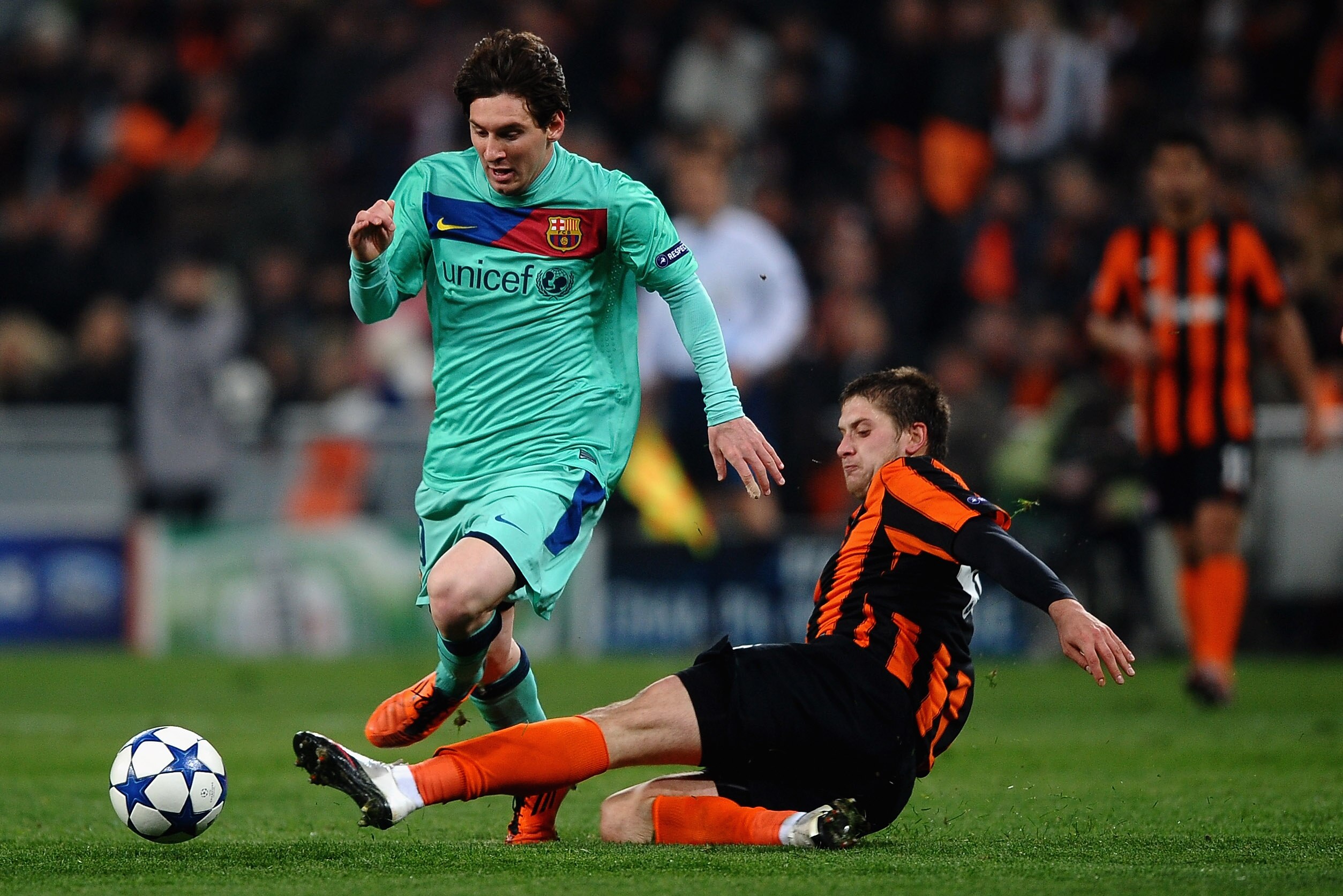 DONETSK, UKRAINE - APRIL 12:  Lionel Messi of Barcelona battles with Yoroslav Rakitskiy of Shakhtar Donetsk during the UEFA Champions League Quarter Final 2nd Leg match between Shakhtar Donetsk and Barcelona at the Donbass Arena on April 12, 2011 in Donet