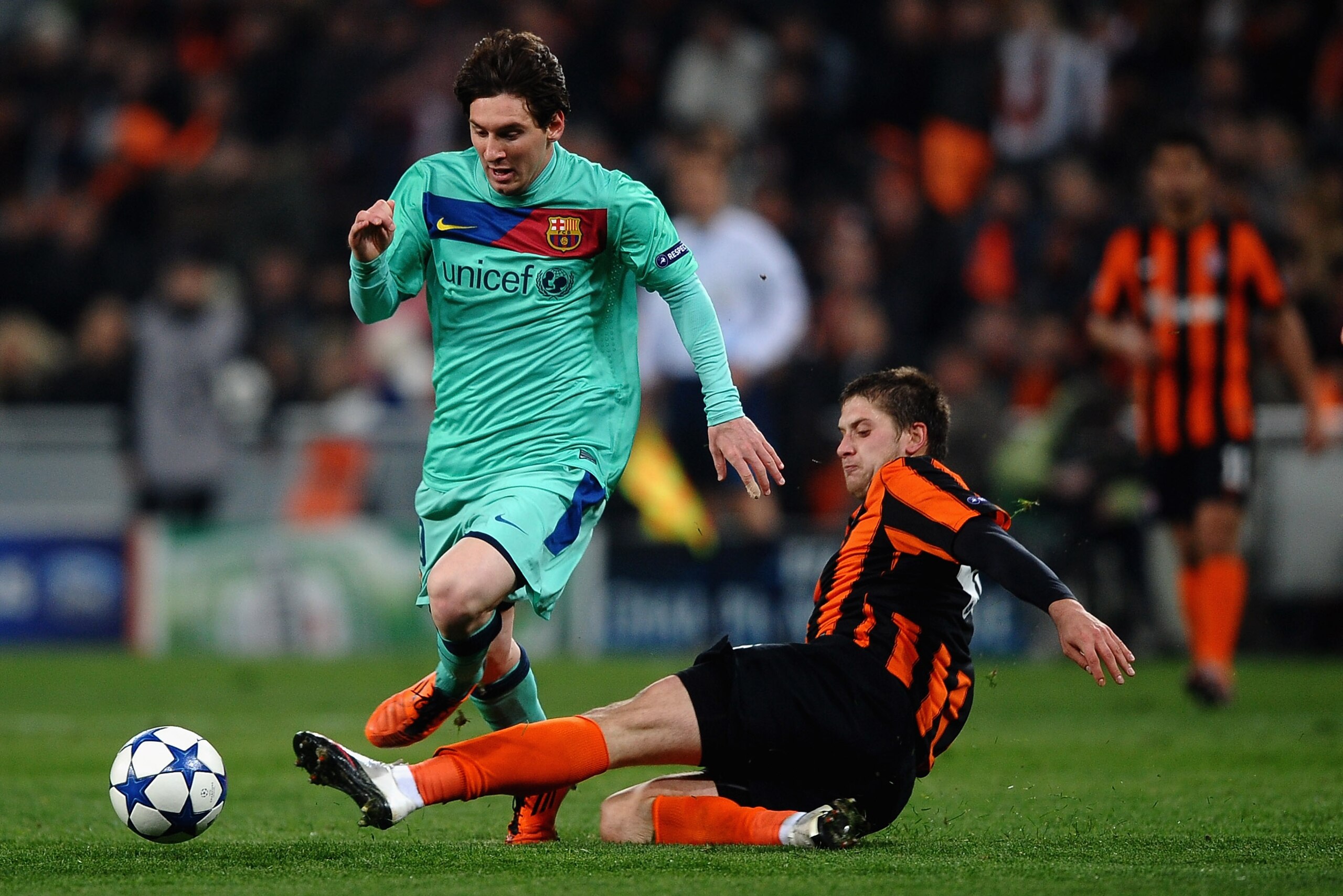 DONETSK, UKRAINE - APRIL 12:  Lionel Messi of Barcelona battles with Yoroslav Rakitskiy of Shakhtar Donetsk during the UEFA Champions League Quarter Final 2nd Leg match between Shakhtar Donetsk and Barcelona at the Donbass Arena on April 12, 2011 in Donet