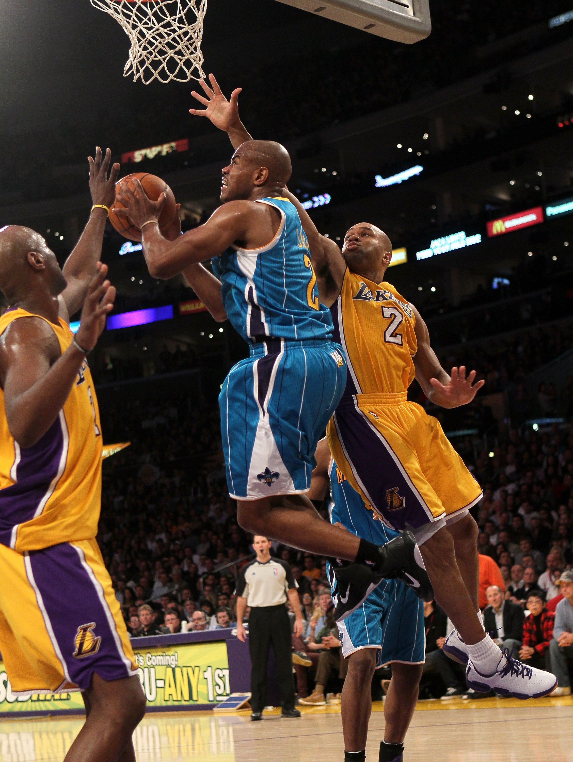 LOS ANGELES, CA - JANUARY 07:  Jarrett Jack #2 of the New Orleans Hornets goes up for a shot between Derek Fisher #2 and Lamar Odom #7 of the Los Angeles Lakers at Staples Center on January 7, 2011 in Los Angeles, California.  The Lakers won 101-97.  NOTE