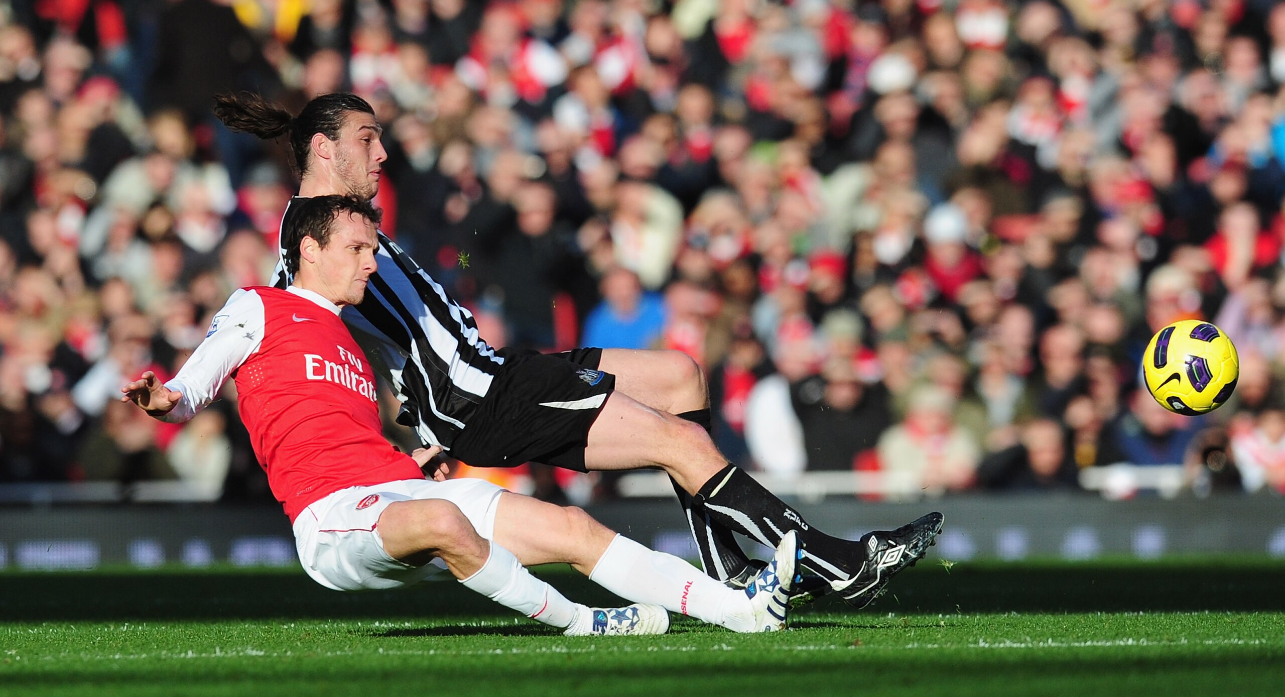 LONDON, ENGLAND - NOVEMBER 07:  Andy Carroll of Newcastle challenges Laurent Koscielny of Arsenal during the Barclays Premier League match between Arsenal and Newcastle United at the Emirates Stadium on November 7, 2010 in London, England.  (Photo by Mike