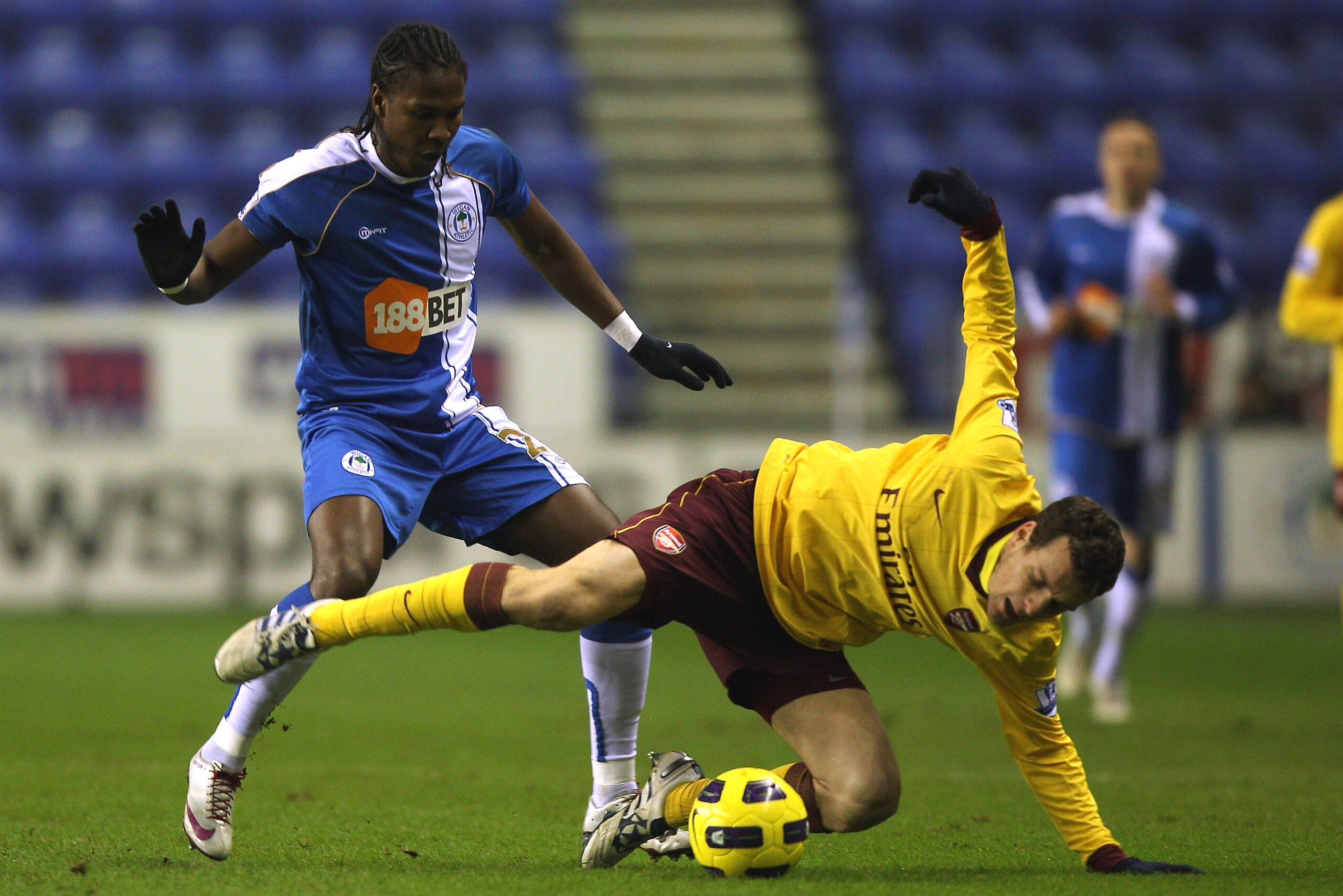 WIGAN, ENGLAND - DECEMBER 29:  Hugo Rodallega (L) of Wigan Athletic tackles Sebastien Squillaci (R) of Arsenal during the Barclays Premier League match between Wigan Athletic and Arsenal at DW Stadium on December 29, 2010 in Wigan, England.  (Photo by Mic