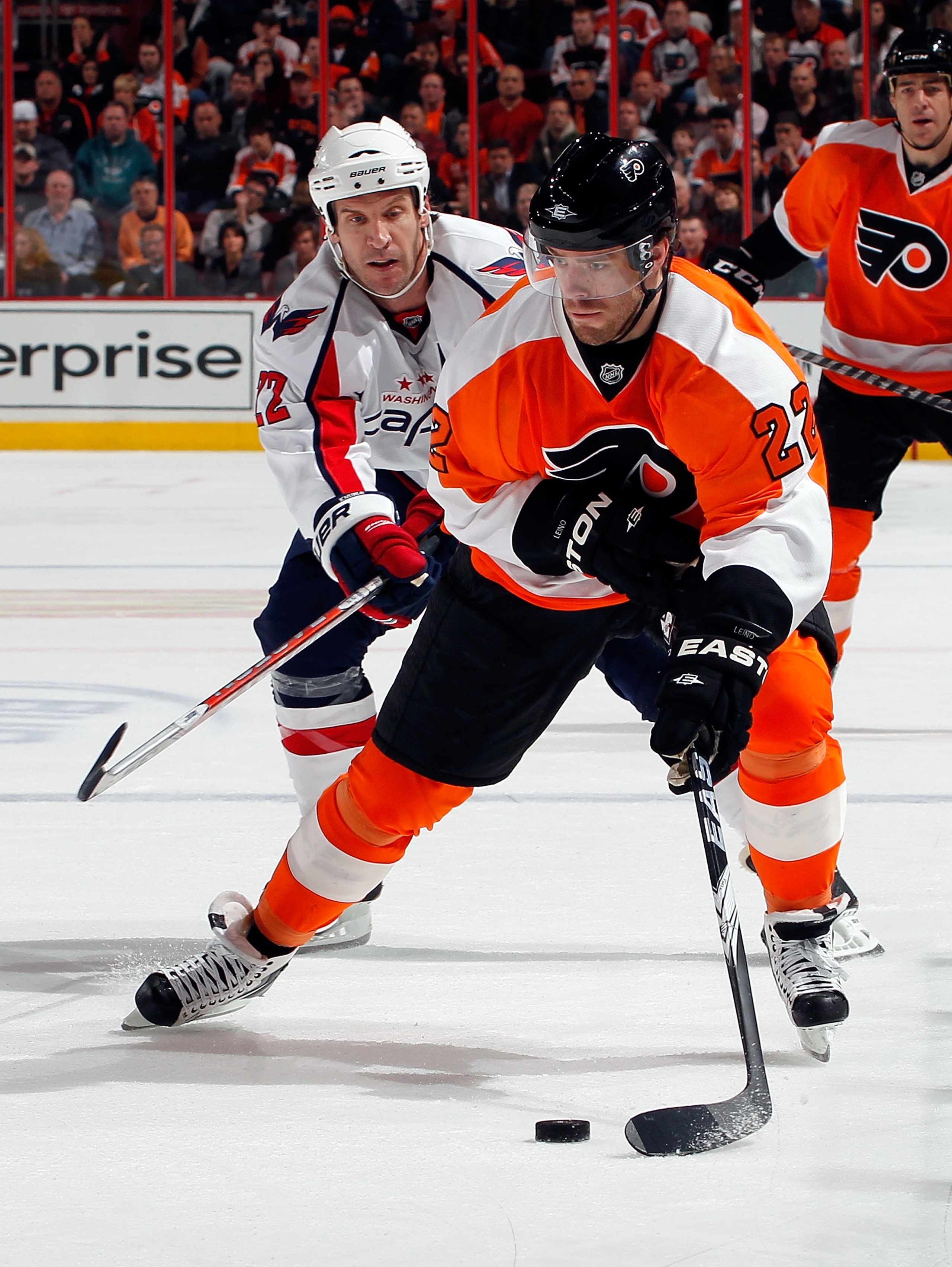 PHILADELPHIA, PA - MARCH 22:  Mike Knuble #22 of the Washington Capitals skates after Ville Leino #22 of the Philadelphia Flyers during an NHL hockey game at the Wells Fargo Center on March 22, 2011 in Philadelphia, Pennsylvania.  (Photo by Paul Bereswill