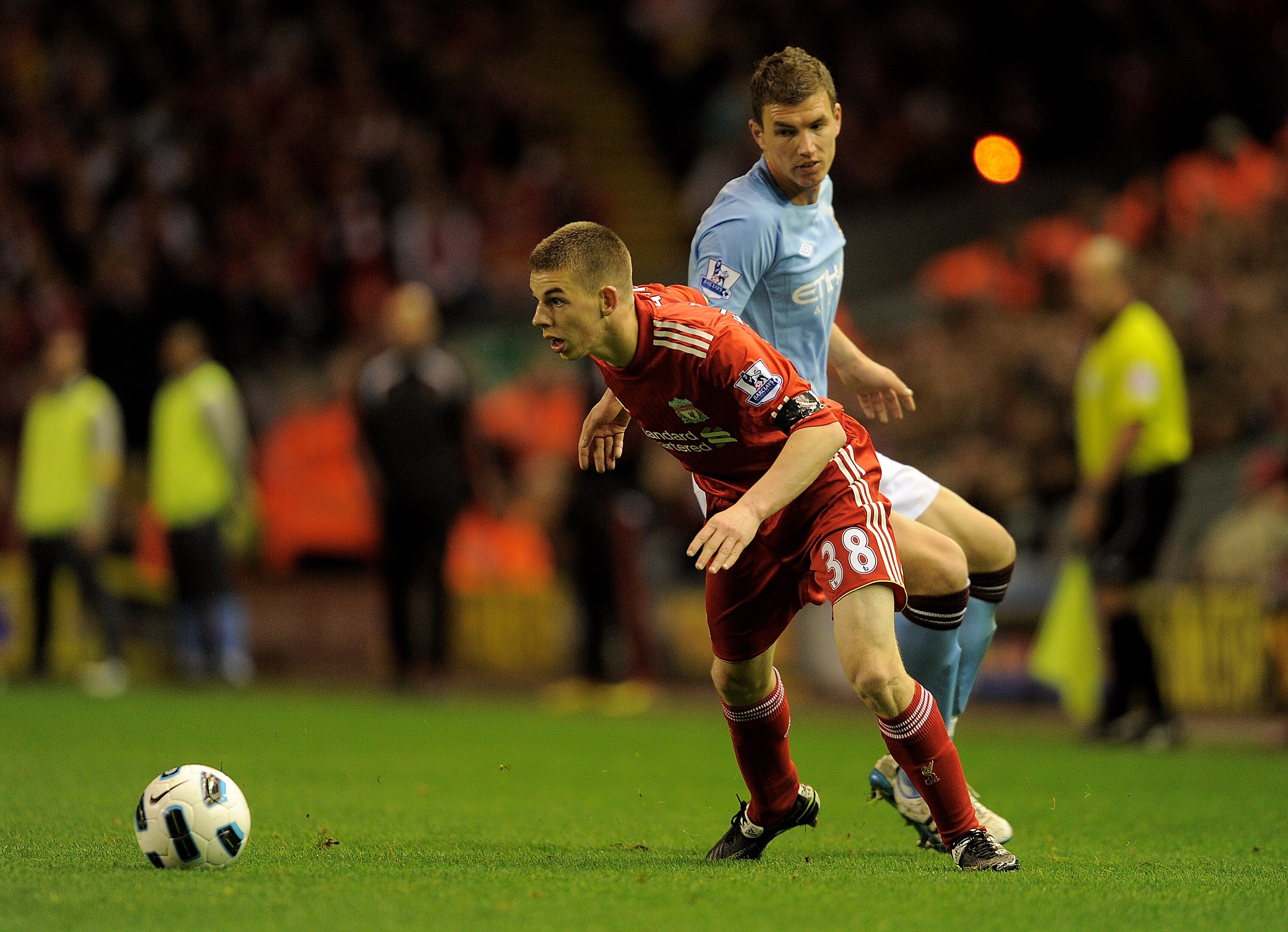 LIVERPOOL, ENGLAND - APRIL 11: John Flanagan of Liverpool competes with Edin Dzeko of Manchester City during the Barclays Premier League match between Liverpool and Manchester City at Anfield on April 11, 2011 in Liverpool, England. (Photo by Michael Re LIVERPOOL, ENGLAND - APRIL 11: John Flanagan of Liverpool competes with Edin Dzeko of Manchester City during the Barclays Premier League match between Liverpool and Manchester City at Anfield on April 11, 2011 in Liverpool, England. (Photo by Michael Re