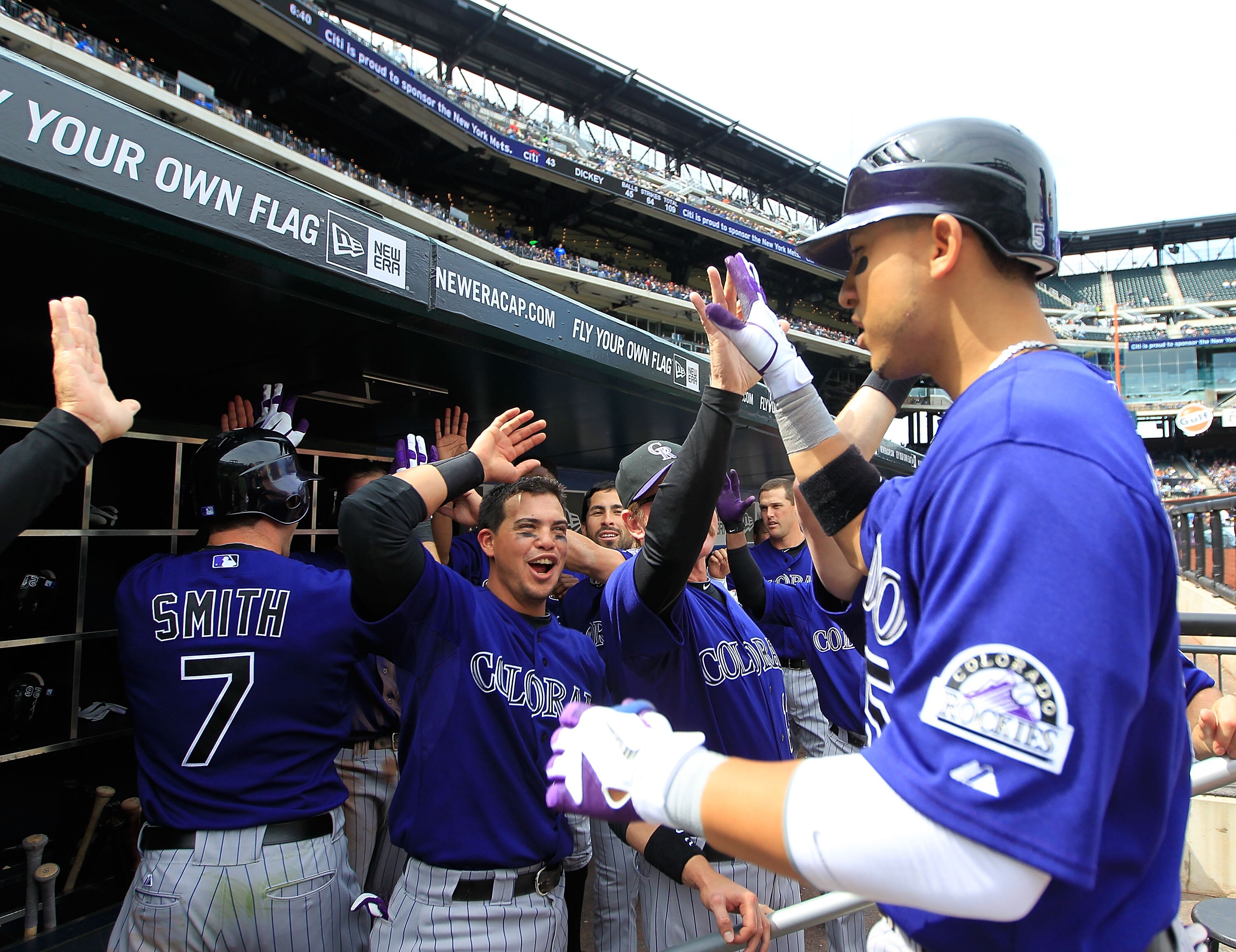 NEW YORK, NY - APRIL 14:  Carlos Gonzalez #5 of the Colorado Rockies is congratulated by his teammates on his seventh-inning home run against the New York Mets at Citi Field on April 14, 2011 in the Flushing neighborhood of the Queens borough of New York