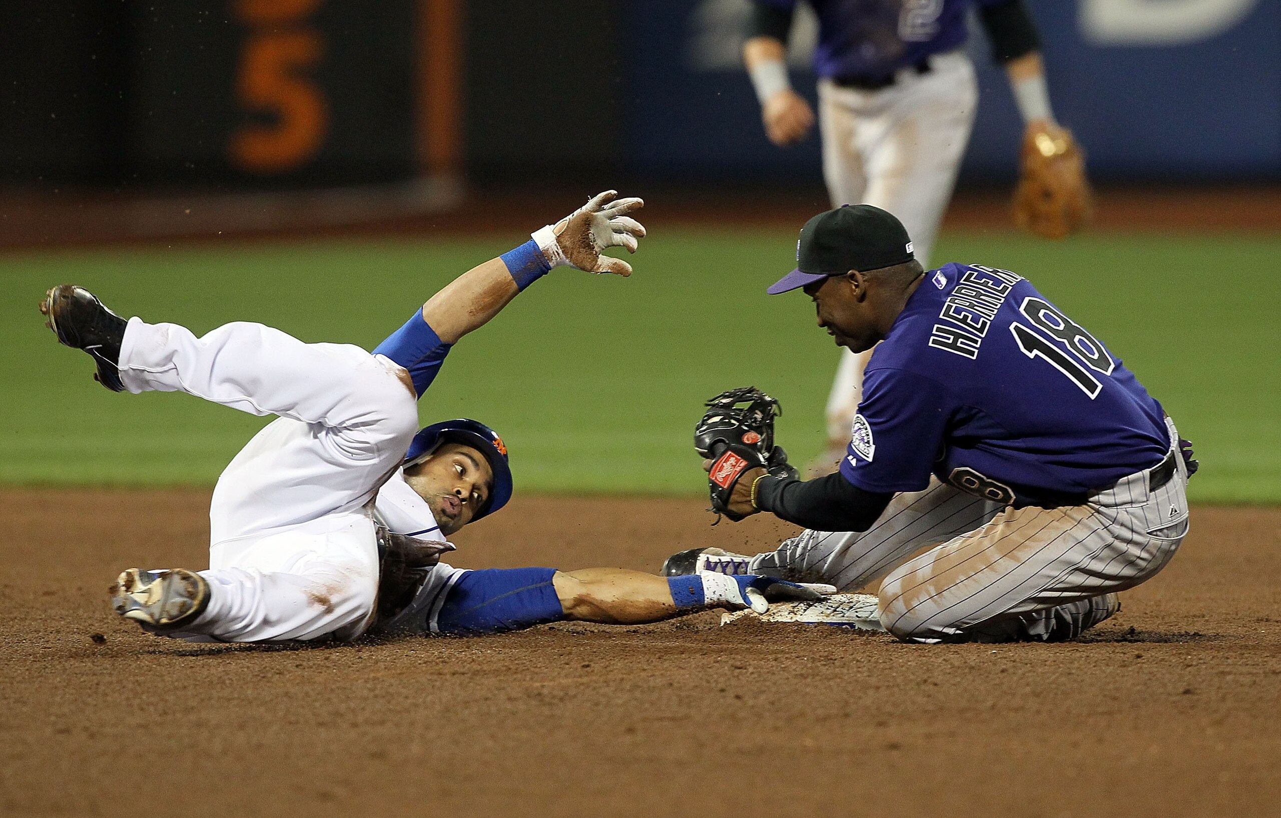 NEW YORK, NY - APRIL 11:  Angel Pagan #16 of the New York Mets is tagged out by Jonathan Herrera #18 of the Colorado Rockies trying to run out a double in the sixth inning on April 11, 2011 at Citi Field in the Flushing neighborhood of the Queens borough