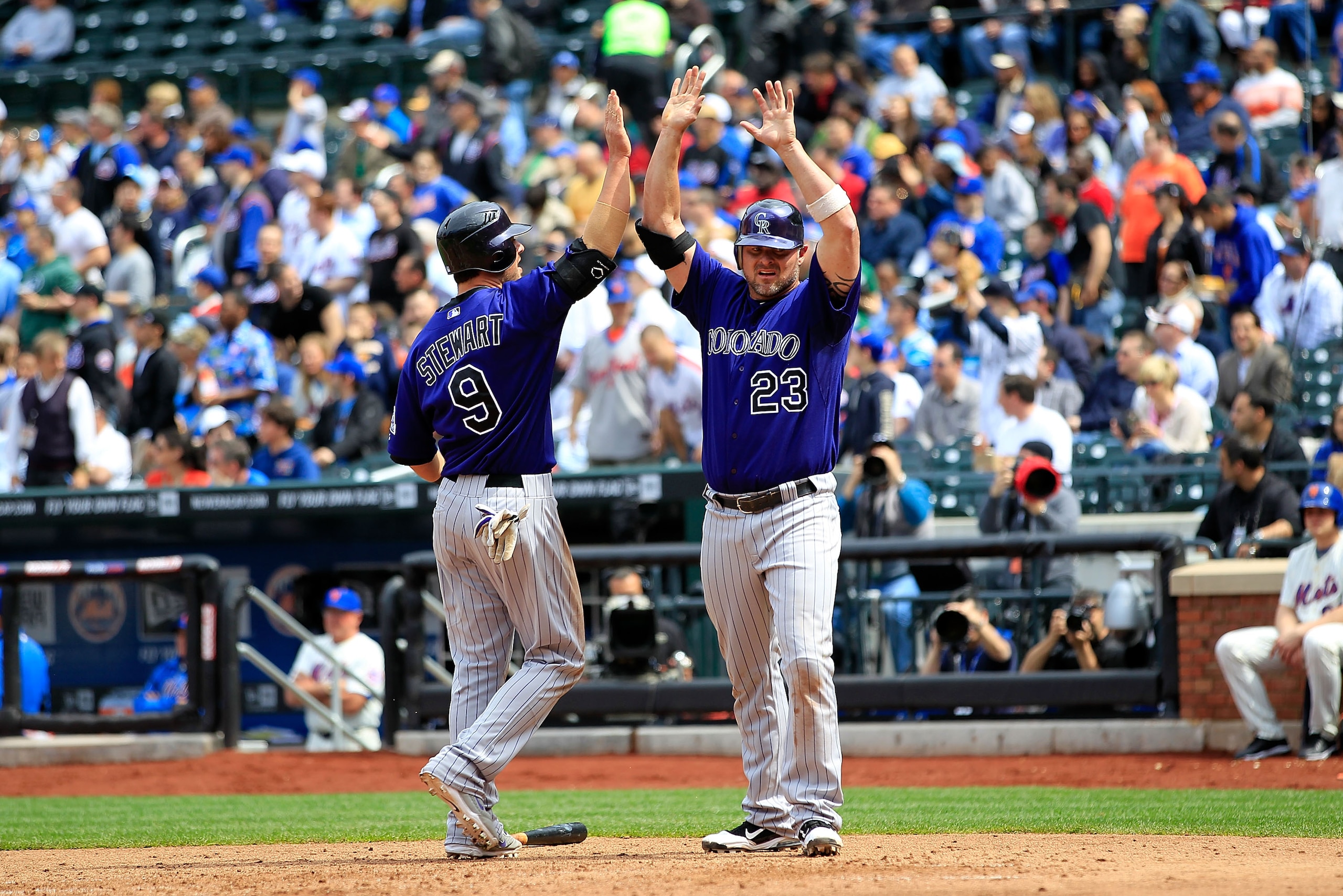NEW YORK, NY - APRIL 14: Ian Stewart #9 and Jason Giambi #23 of the Colorado Rockies celebrate scoring two runs in the sixth inning against the New York Mets at Citi Field on April 14, 2011 in the Flushing neighborhood of the Queens borough of New York Ci