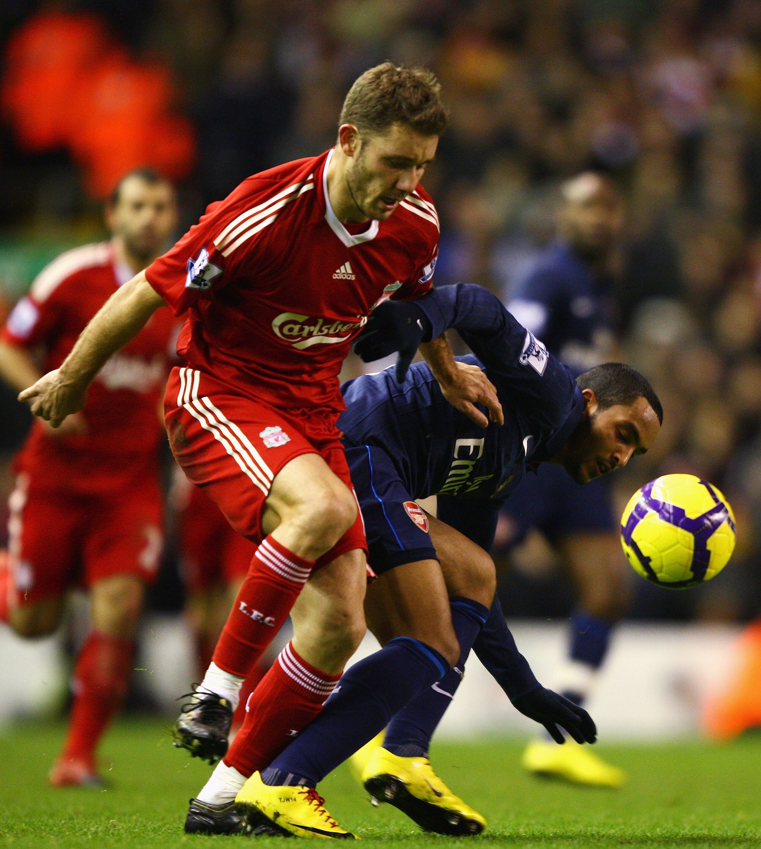 LIVERPOOL, ENGLAND - DECEMBER 13:  Fabio Aurelio of Liverpool tangles with Theo Walcott of Arsenal during the Barclays Premier League match between Liverpool and Arsenal at Anfield on December 13, 2009 in Liverpool, England.  (Photo by Clive Brunskill/Get