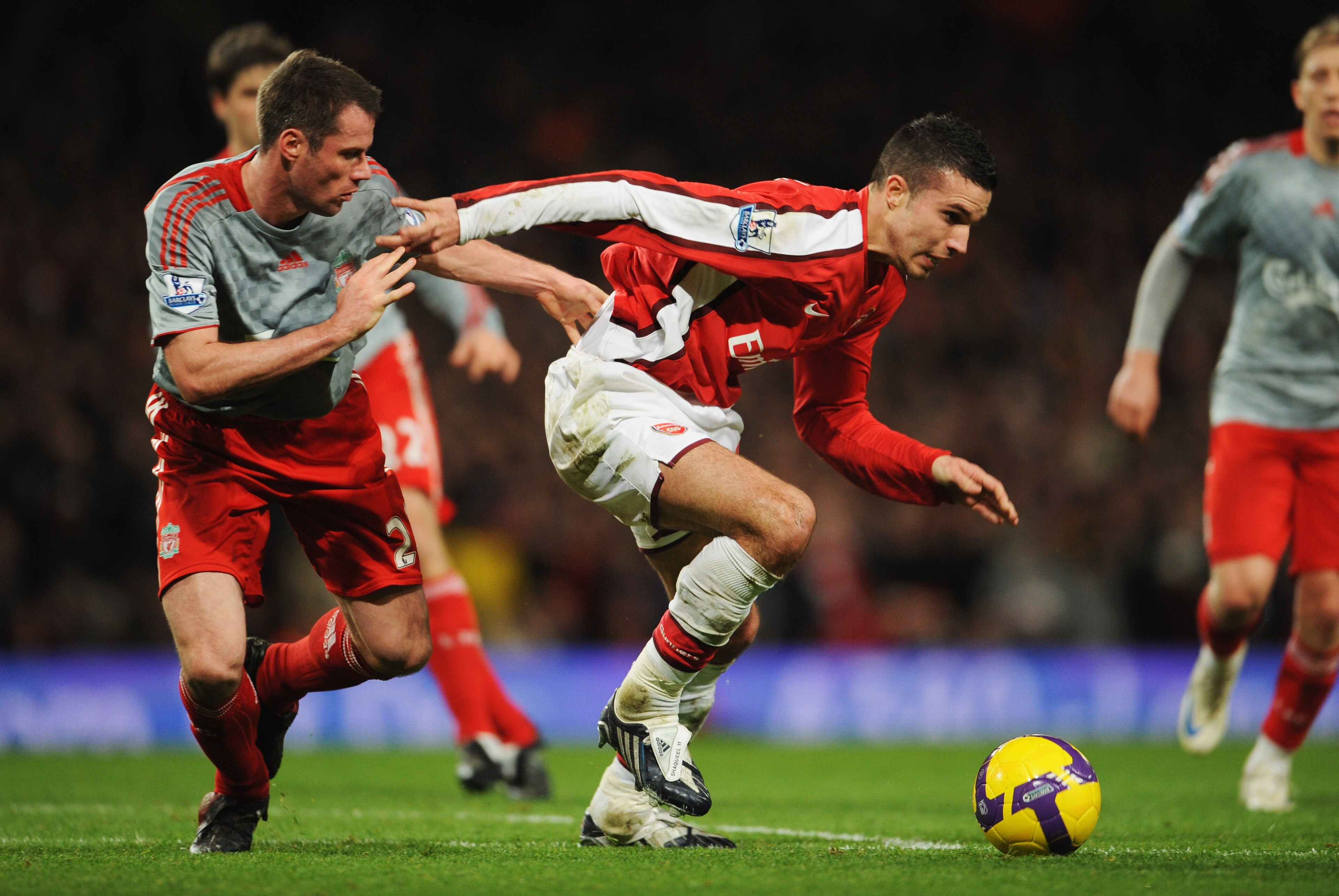 LONDON - DECEMBER 21: Robin van Persie of Arsenal holds off Jamie Carragher of Liverpool during the Barclays Premier League match between Arsenal and Liverpool at the Emirates Stadium on December 21, 2008 in London, England. (Photo by Clive Mason/Getty LONDON - DECEMBER 21: Robin van Persie of Arsenal holds off Jamie Carragher of Liverpool during the Barclays Premier League match between Arsenal and Liverpool at the Emirates Stadium on December 21, 2008 in London, England. (Photo by Clive Mason/Getty