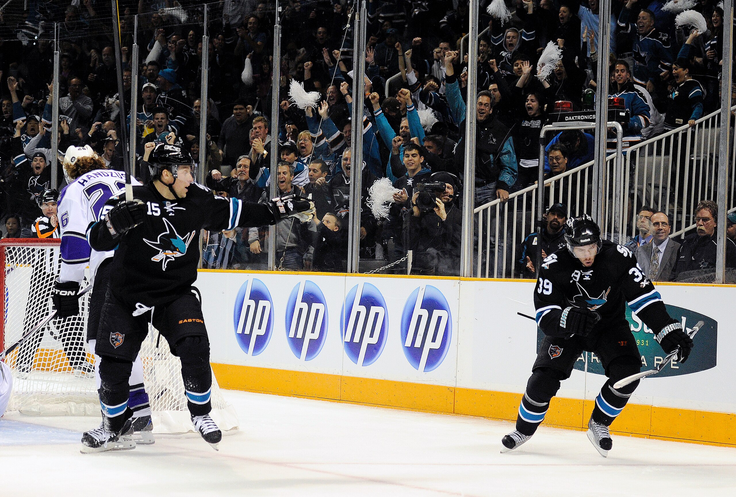 SAN JOSE, CA - APRIL 14: Logan Couture #39 and Dany Heatley #15 of the San Jose Sharks celebrates after Couture scores a goal against the Los Angeles Kings in Game One of the Western Conference Quarterfinals  during the 2011 NHL Stanley Cup Playoffs at th