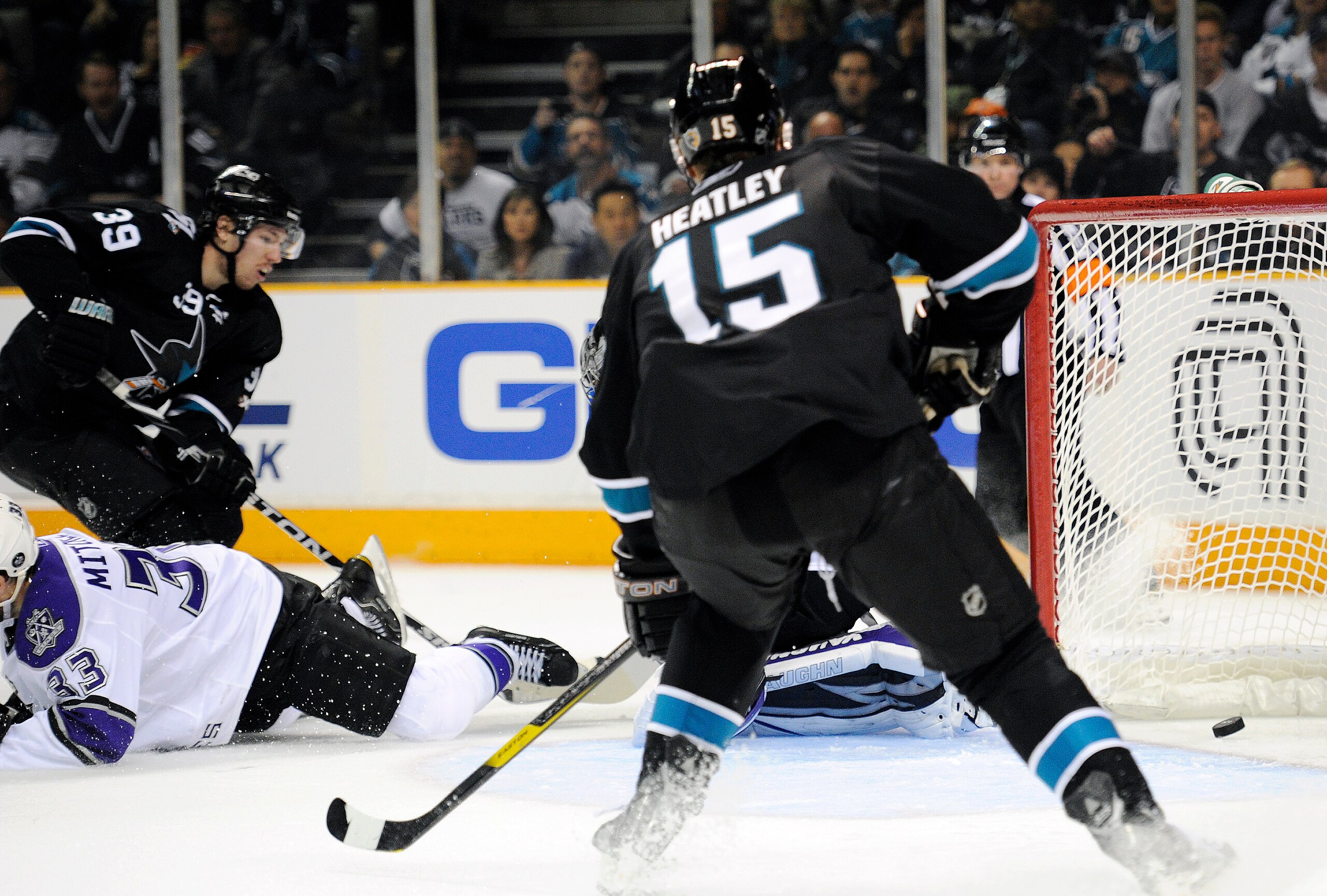SAN JOSE, CA - APRIL 14: Logan Couture #39 of the San Jose Sharks scores a goal getting his shot pass Willie Mitchell #33 and Jonathan Quick #32 of  the Los Angeles Kings in Game One of the Western Conference Quarterfinals  during the 2011 NHL Stanley Cup