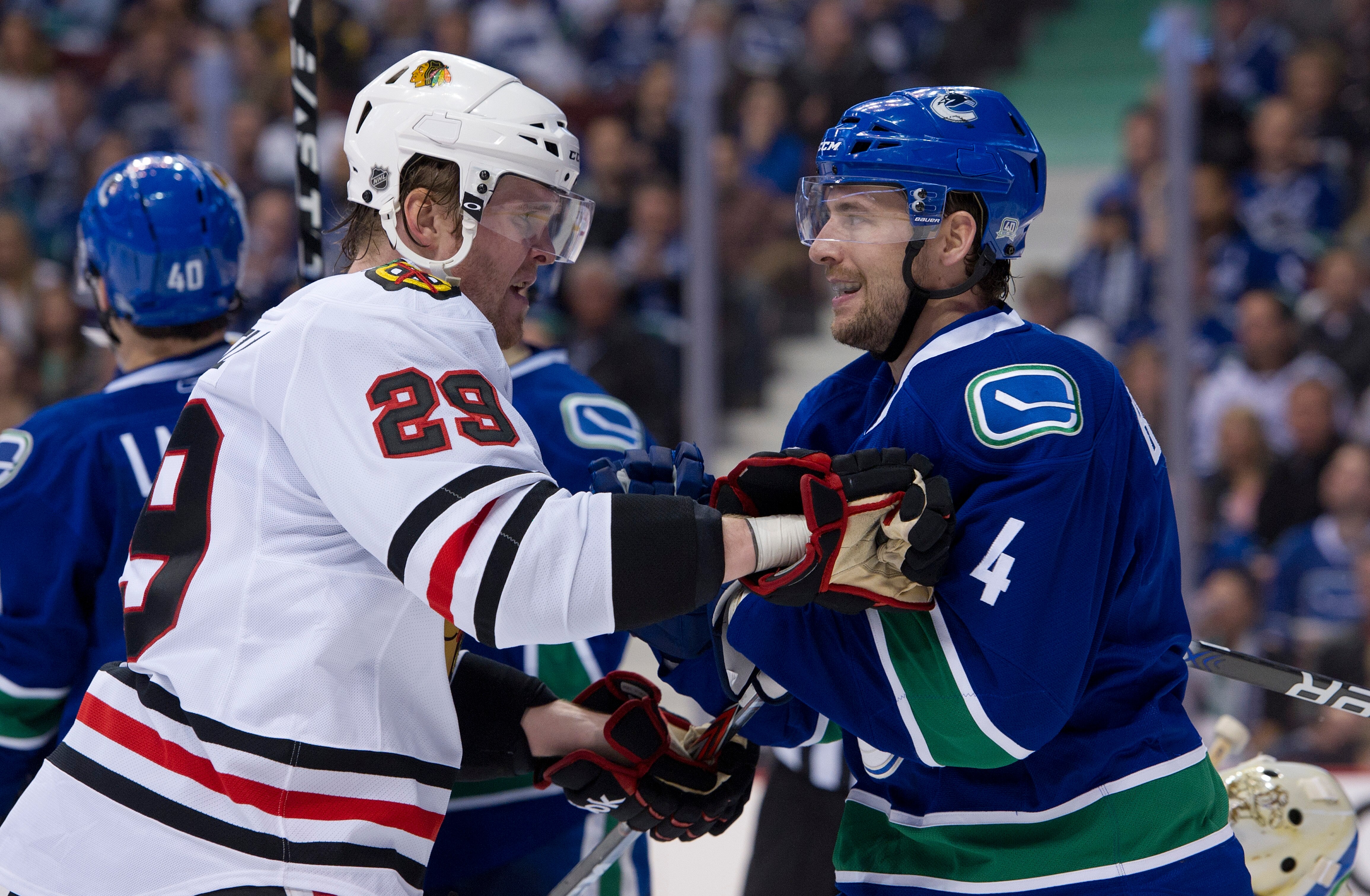 VANCOUVER, CANADA - APRIL 13: Keith Ballard #4 of the Vancouver Canucks and Bryan Bickell #29 of the Chicago Blackhawks exchange words after the whistle during the third period in Game One of the Western Conference Quarterfinals during the 2011 NHL Stanle