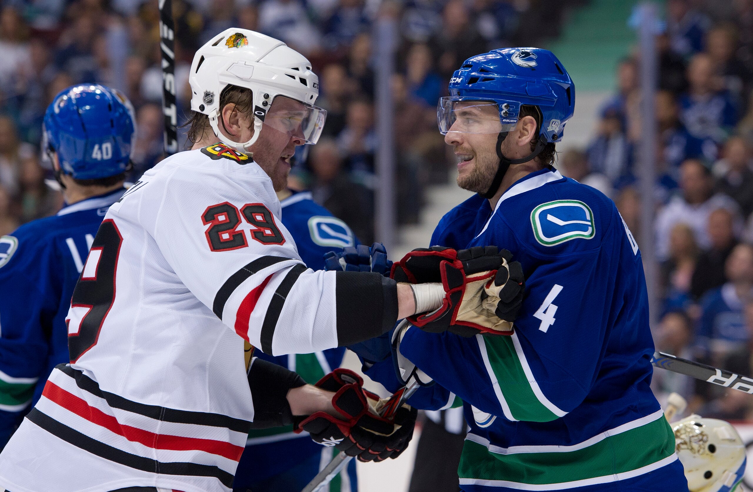 VANCOUVER, CANADA - APRIL 13: Keith Ballard #4 of the Vancouver Canucks and Bryan Bickell #29 of the Chicago Blackhawks exchange words after the whistle during the third period in Game One of the Western Conference Quarterfinals during the 2011 NHL Stanle