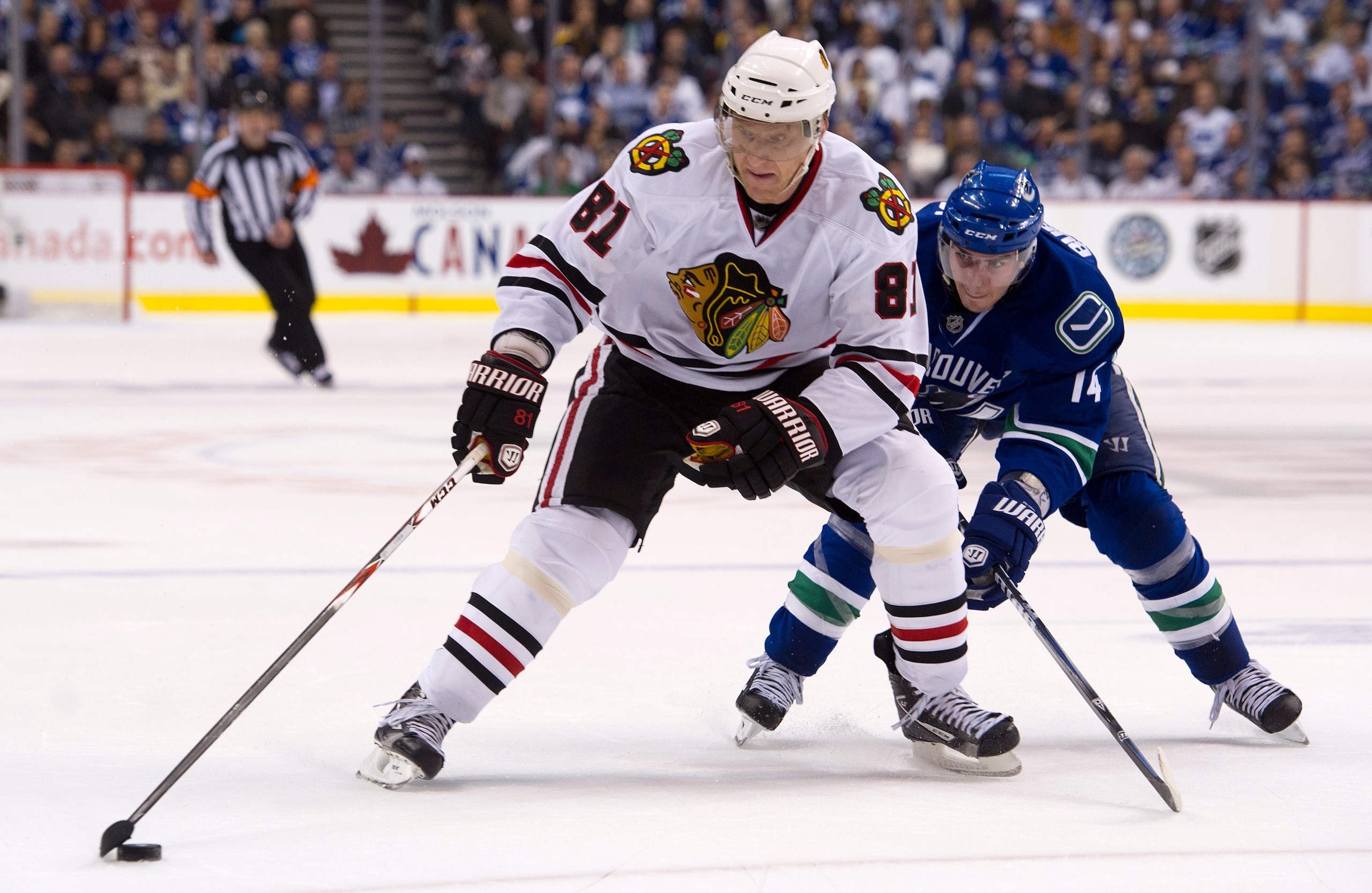 VANCOUVER, CANADA - APRIL 13: Alexandre Burrows #14 of the Vancouver Canucks tries to stop Marian Hossa #81of the Chicago Blackhawks from getting to the front of the net during the third period in Game One of the Western Conference Quarterfinals during th