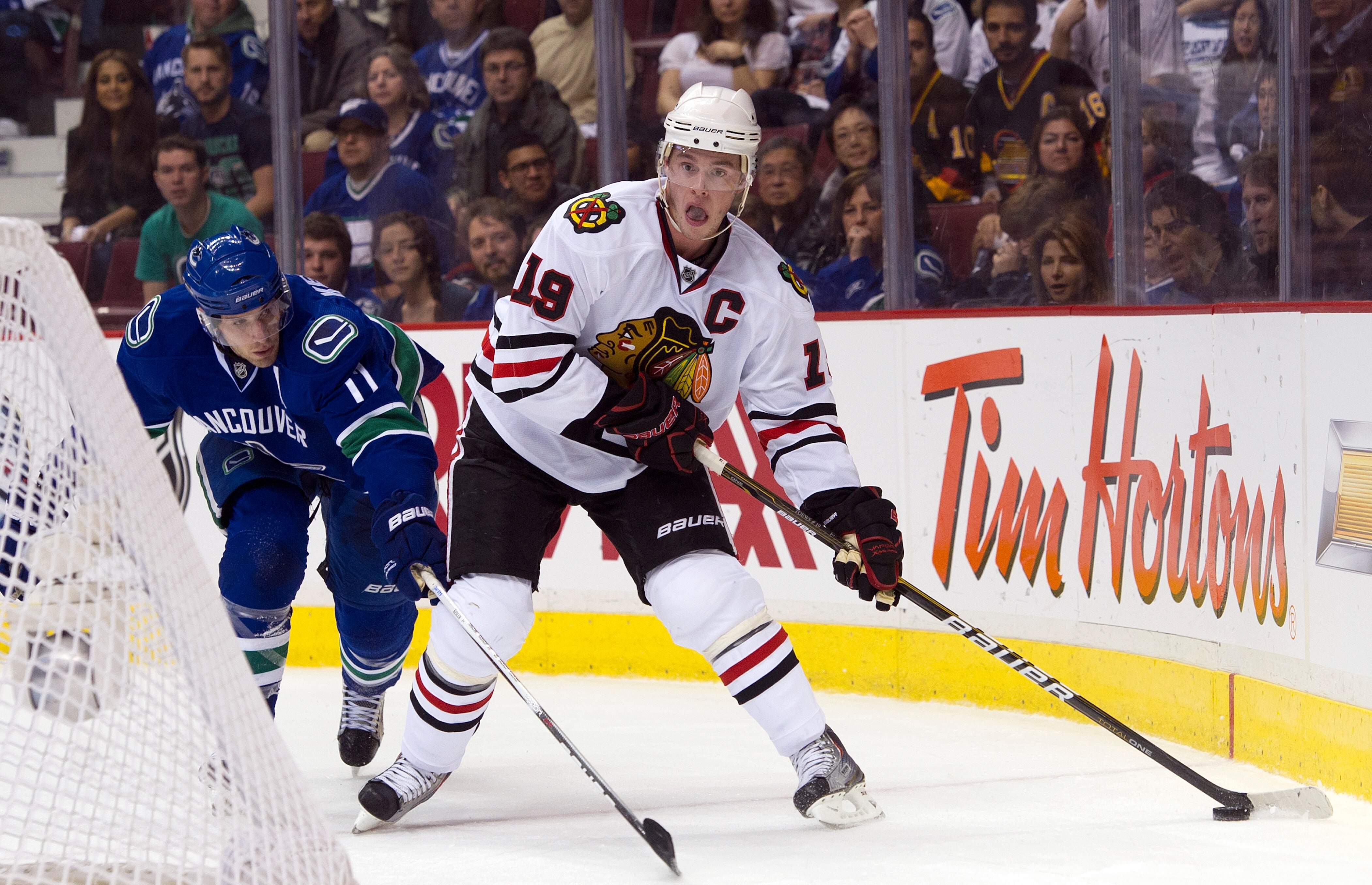 VANCOUVER, CANADA - APRIL 13: Jonathan Toews #19 of the Chicago Blackhawks tries to get to the front of the net while being defended by Ryan Kesler #17 of the Vancouver Canucks during the first period in Game One of the Western Conference Quarterfinals du