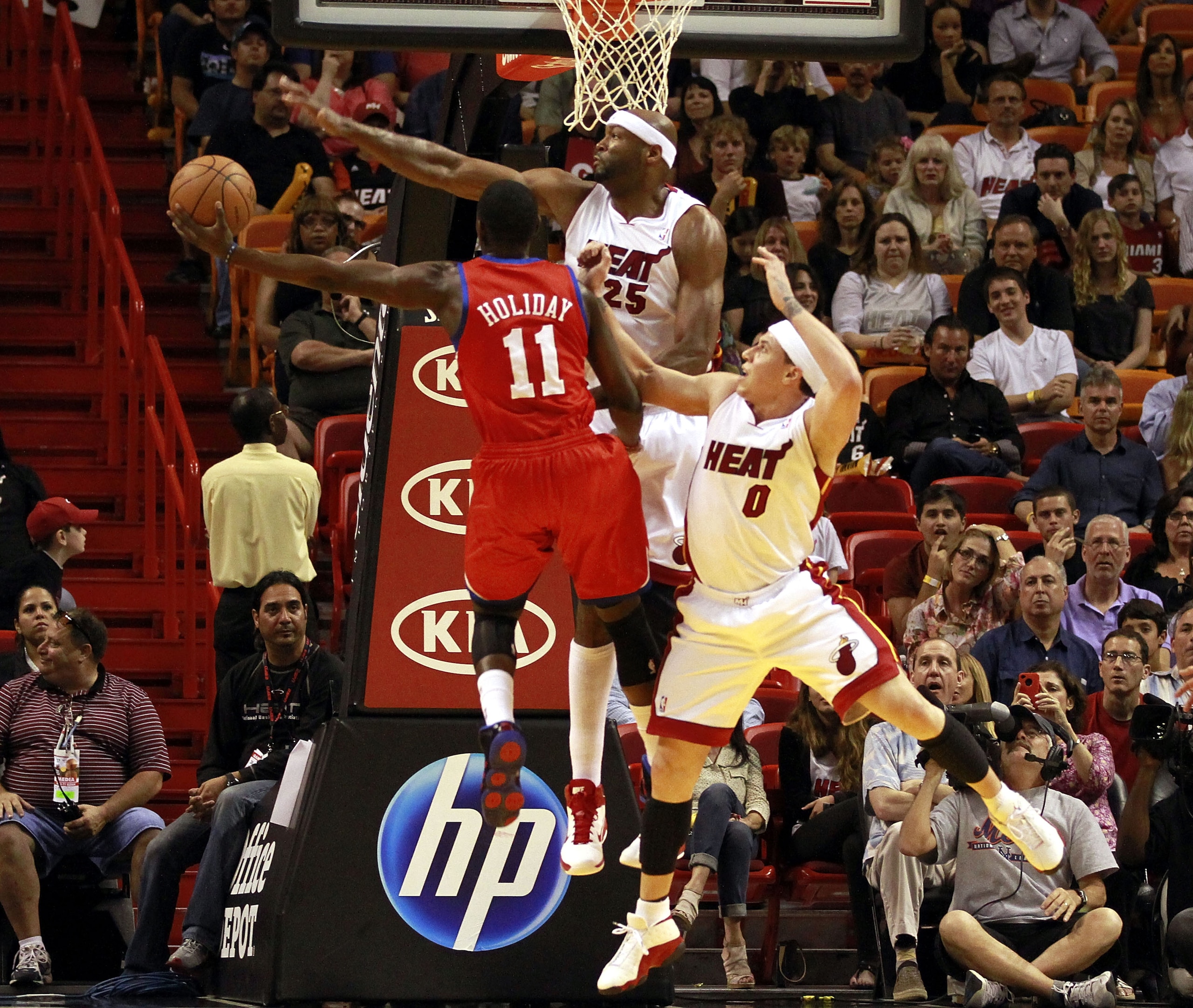 MIAMI, FL - MARCH 25: Center Erick Dampier #25 and guard Mike Bibby #0 of the Miami Heat defend against Forward Jrue Holiday #11 of the Philadelphia 76ers at American Airlines Arena on March 25, 2011 in Miami, Florida. The Heat defeated the Sixers 111-99 MIAMI, FL - MARCH 25: Center Erick Dampier #25 and guard Mike Bibby #0 of the Miami Heat defend against Forward Jrue Holiday #11 of the Philadelphia 76ers at American Airlines Arena on March 25, 2011 in Miami, Florida. The Heat defeated the Sixers 111-99