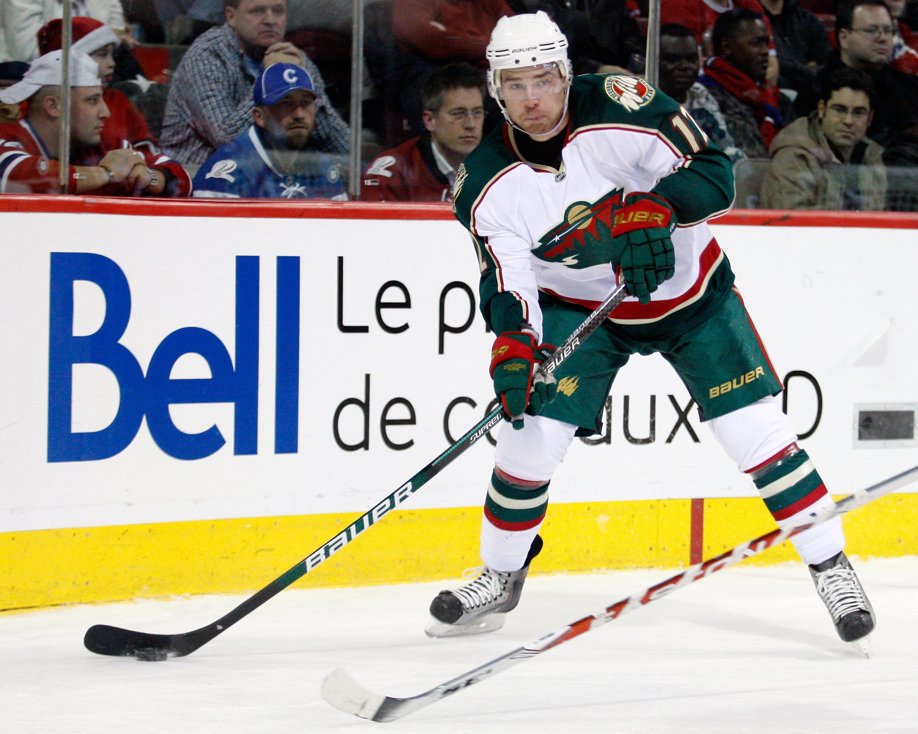 MONTREAL- DECEMBER 17:  Chuck Kobasew #12 of the Minnesota Wild passes the puck during the NHL game against the Montreal Canadiens on December 17, 2009 at the Bell Centre in Montreal, Quebec, Canada.  The Wild defeated the Canadiens 3-1.  (Photo by Richar