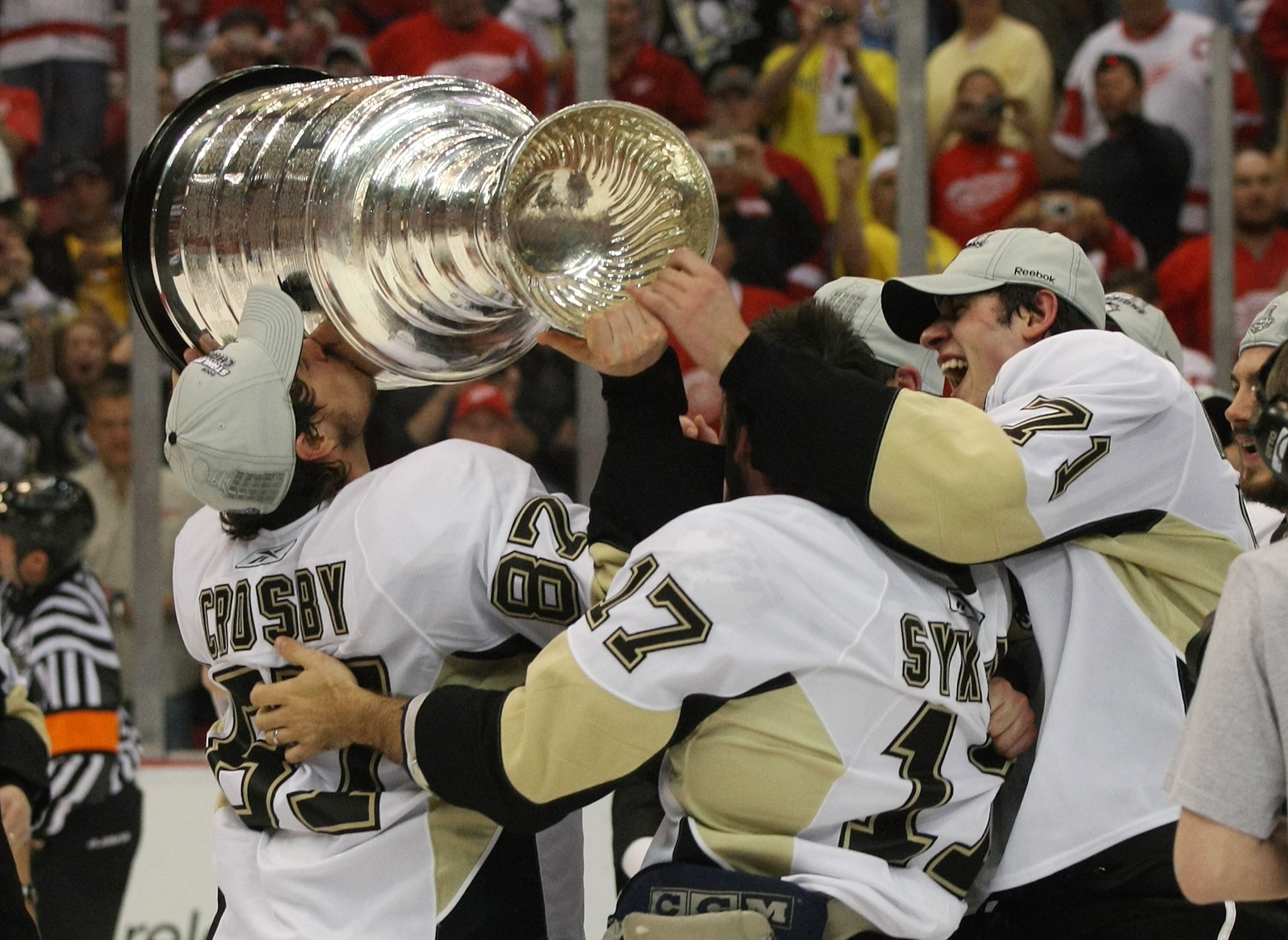 DETROIT - JUNE 12: (L-R) Sideny Crosby #87, Petr Sykora #17 and Evgeni Malkin #71 of the Pittsburgh Penguins hold  the Stanley Cup following the Penguins victory over the Detroit Red Wings in Game Seven of the 2009 NHL Stanley Cup Finals at Joe Louis Aren