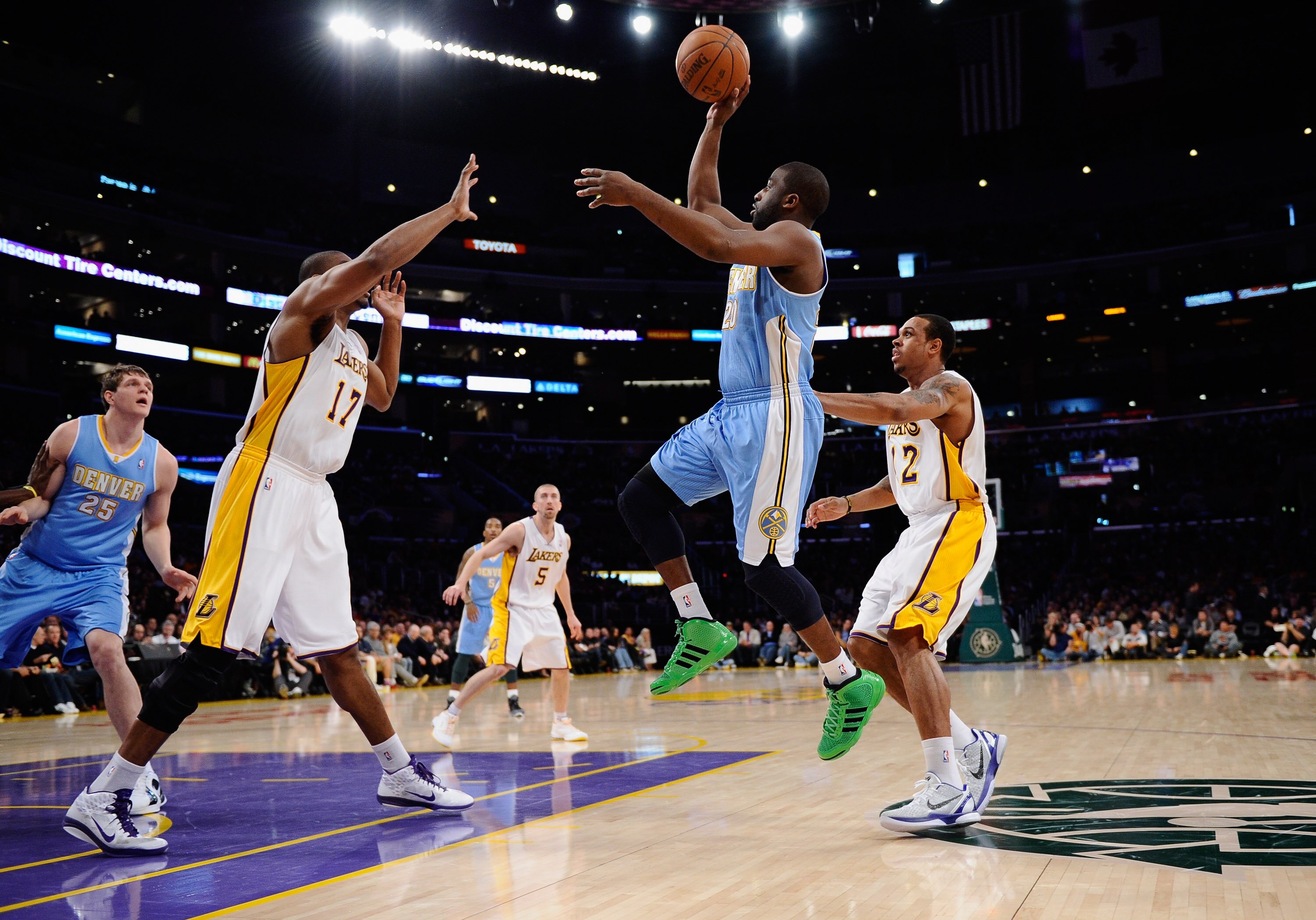 LOS ANGELES, CA - APRIL 03:  Raymond Felton #20 of the Denver Nuggets shoots over Andrew Bynum #17 and Shannon Brown #12 of the Los Angeles Lakers during the game at Staples Center on April 3, 2011 in Los Angeles, California. NOTE TO USER: User expressly 