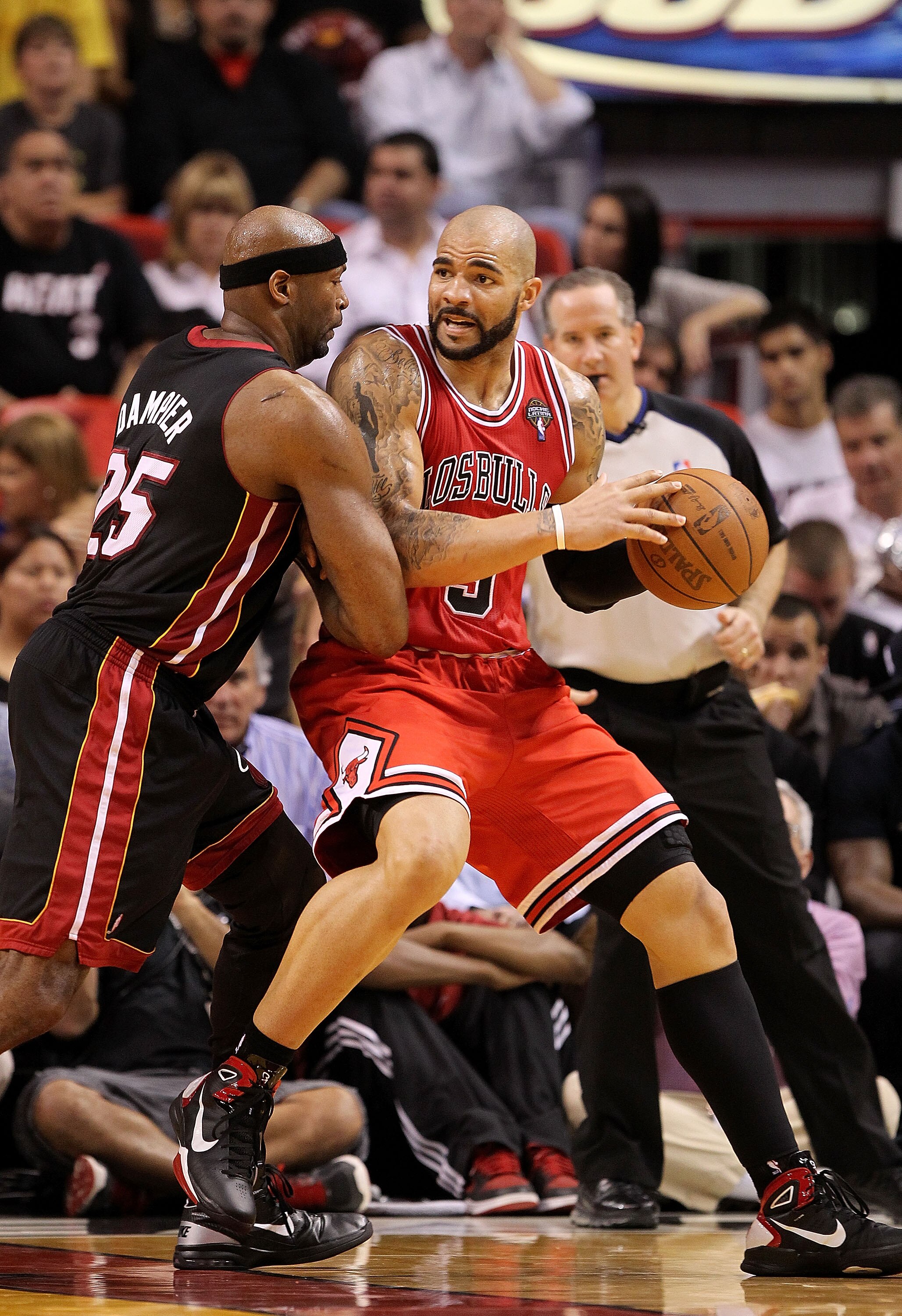 MIAMI, FL - MARCH 06:  Carlos Boozer #5 of the Chicago Bulls posts up Eric Dampier #25 of the Miami Heat during a game at American Airlines Arena on March 6, 2011 in Miami, Florida. NOTE TO USER: User expressly acknowledges and agrees that, by downloading