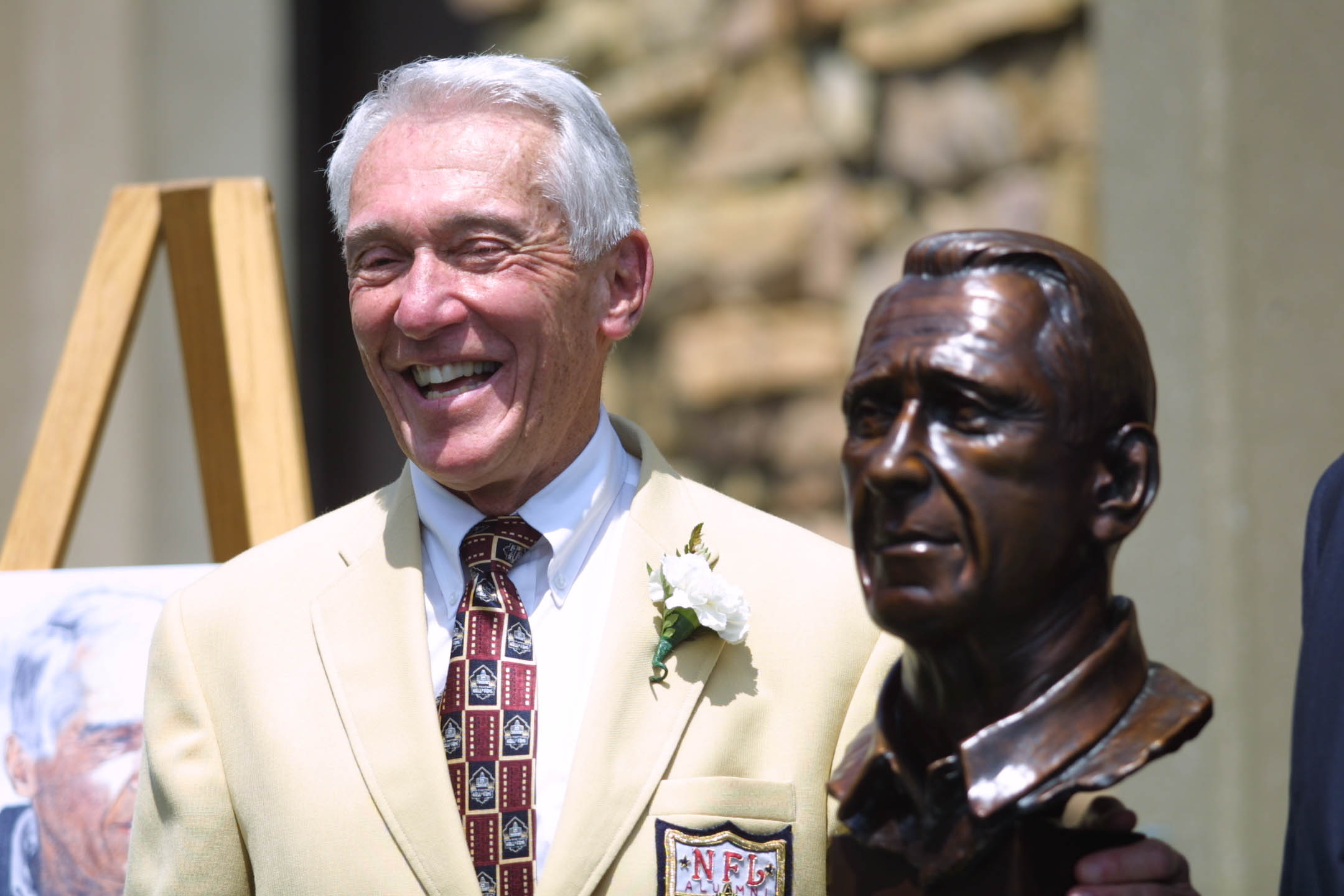 04 Aug 2001 : Marv Levy smiles as he poses next to his bust during the 2001 Pro Football Hall Of Fame Induction Ceremony at Hall's Game Day Theater in Canton, Ohio. DIGITAL IMAGE. Mandatory Credit: Tom Pidgeon/Allsport