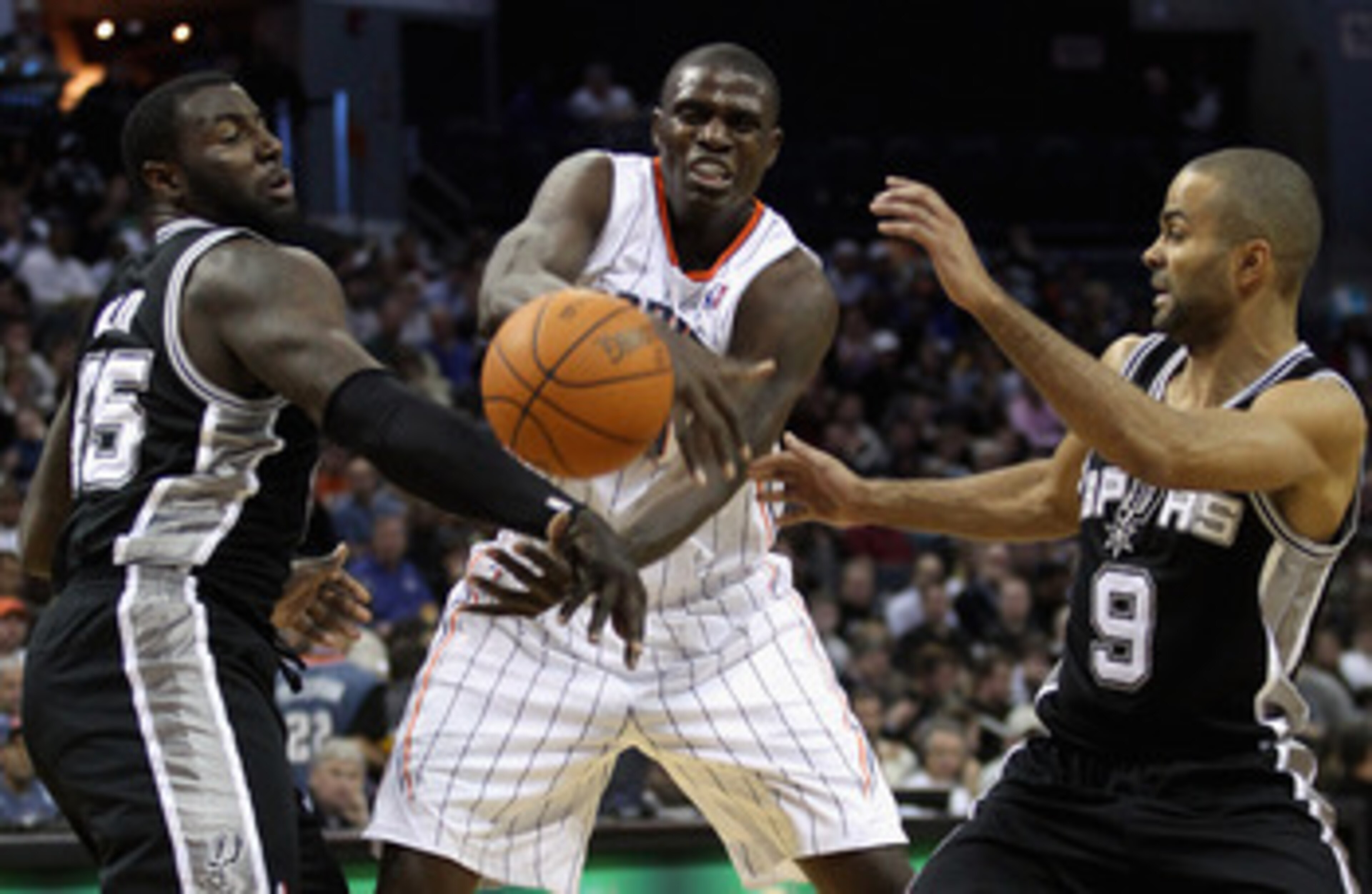 CHARLOTTE, NC - NOVEMBER 08:  Teammates Tony Parker #9 and DeJuan Blair #45 of the San Antonio Spurs battle for a loose ball with Nazr Mohammed #13 of the Charlotte Bobcats during their game at Time Warner Cable Arena on November 8, 2010 in Charlotte, Nor