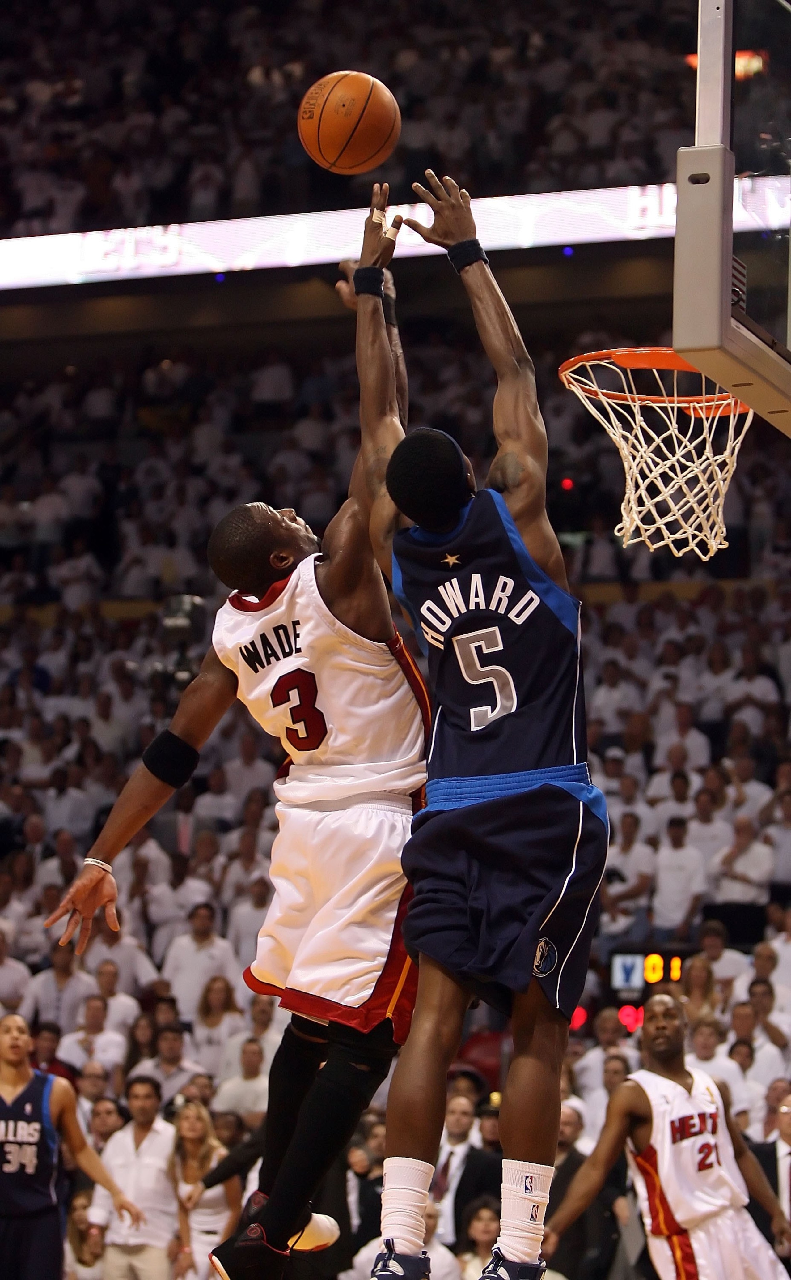 MIAMI - JUNE 13: Dwyane Wade #3 of the Miami Heat knocks the ball out of the way of Josh Howard #5 of the Dallas Mavericks in the final seconds of game three of the 2006 NBA Finals on June 13, 2006 at American Airlines Arena in Miami, Florida. The Heat de