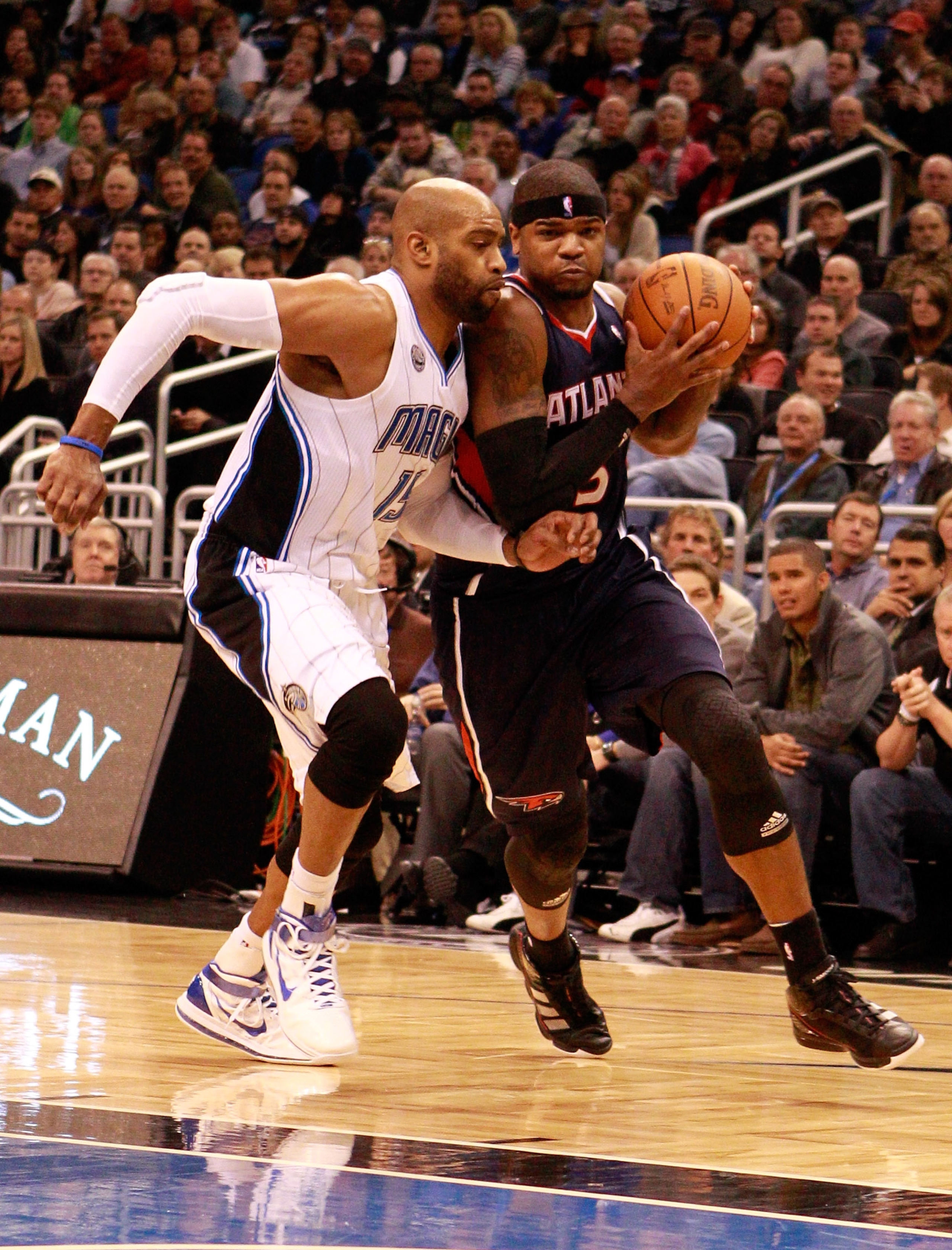ORLANDO, FL - DECEMBER 06: Josh Smith #5 of the Atlanta Hawks drives against Vince Carter#15 of the Orlando Magic during the game at Amway Arena on December 6, 2010 in Orlando, Florida. NOTE TO USER: User expressly acknowledges and agrees that, by downlo ORLANDO, FL - DECEMBER 06: Josh Smith #5 of the Atlanta Hawks drives against Vince Carter#15 of the Orlando Magic during the game at Amway Arena on December 6, 2010 in Orlando, Florida. NOTE TO USER: User expressly acknowledges and agrees that, by downlo