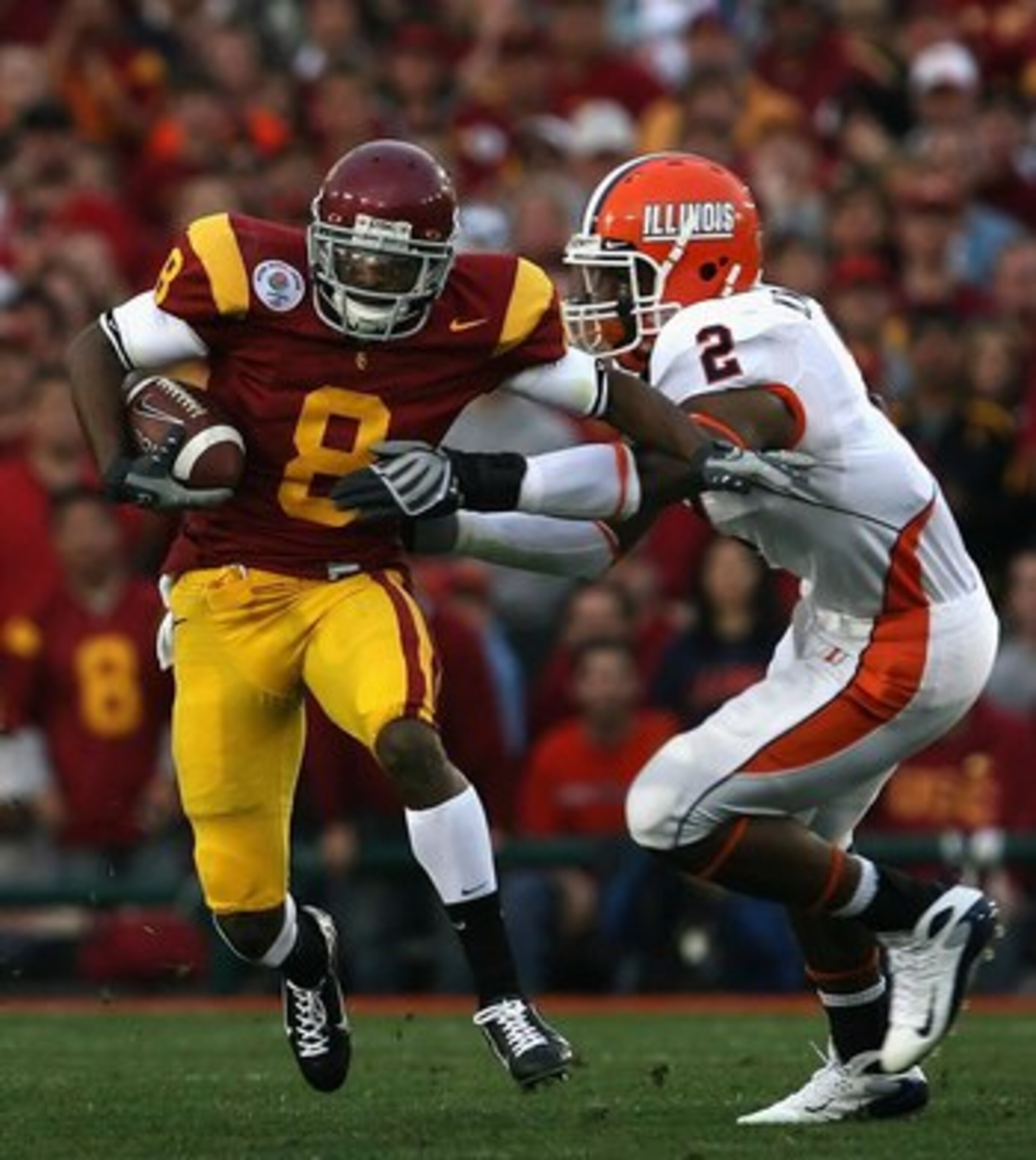 PASADENA, CA - JANUARY 01:  Wide receiver Ronald Johnson #8 of the USC Trojans returns a kick off for 14 yards under pressure from Martez Wilson #2 of the Illinois Fighting Illini during the Rose Bowl presented by Citi at the Rose Bowl on January 1, 2008 