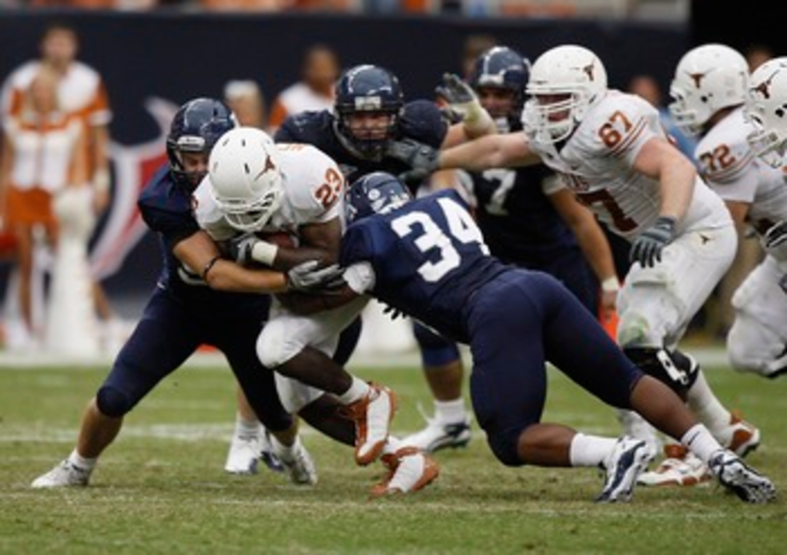 HOUSTON - SEPTEMBER 04: Running back Tre' Newton #23 of the Texas Longhorns is tackled by linebacker Cameron Nwosu #34 of the Rice Owls at Reliant Stadium on September 4, 2010 in Houston, Texas. (Photo by Bob Levey/Getty Images) HOUSTON - SEPTEMBER 04: Running back Tre' Newton #23 of the Texas Longhorns is tackled by linebacker Cameron Nwosu #34 of the Rice Owls at Reliant Stadium on September 4, 2010 in Houston, Texas. (Photo by Bob Levey/Getty Images)
