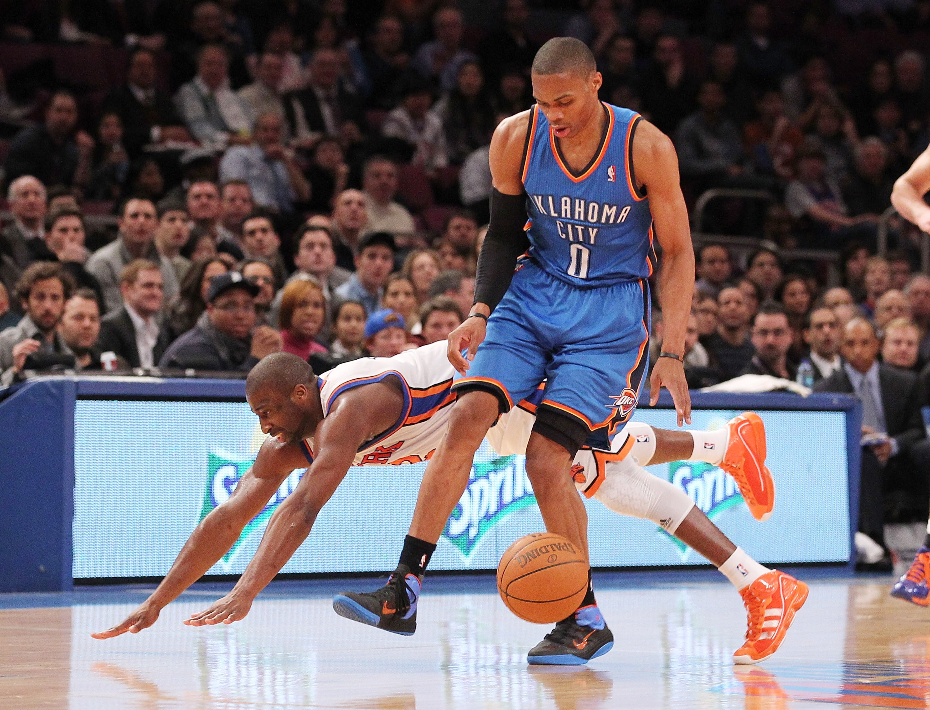 NEW YORK, NY - DECEMBER 22:  Raymond Felton #2 of the New York Knicks collides with Russell Westbrook #0 of the Oklahoma City Thunder at Madison Square Garden on December 22, 2010 in New York City.   NOTE TO USER: User expressly acknowledges and agrees th