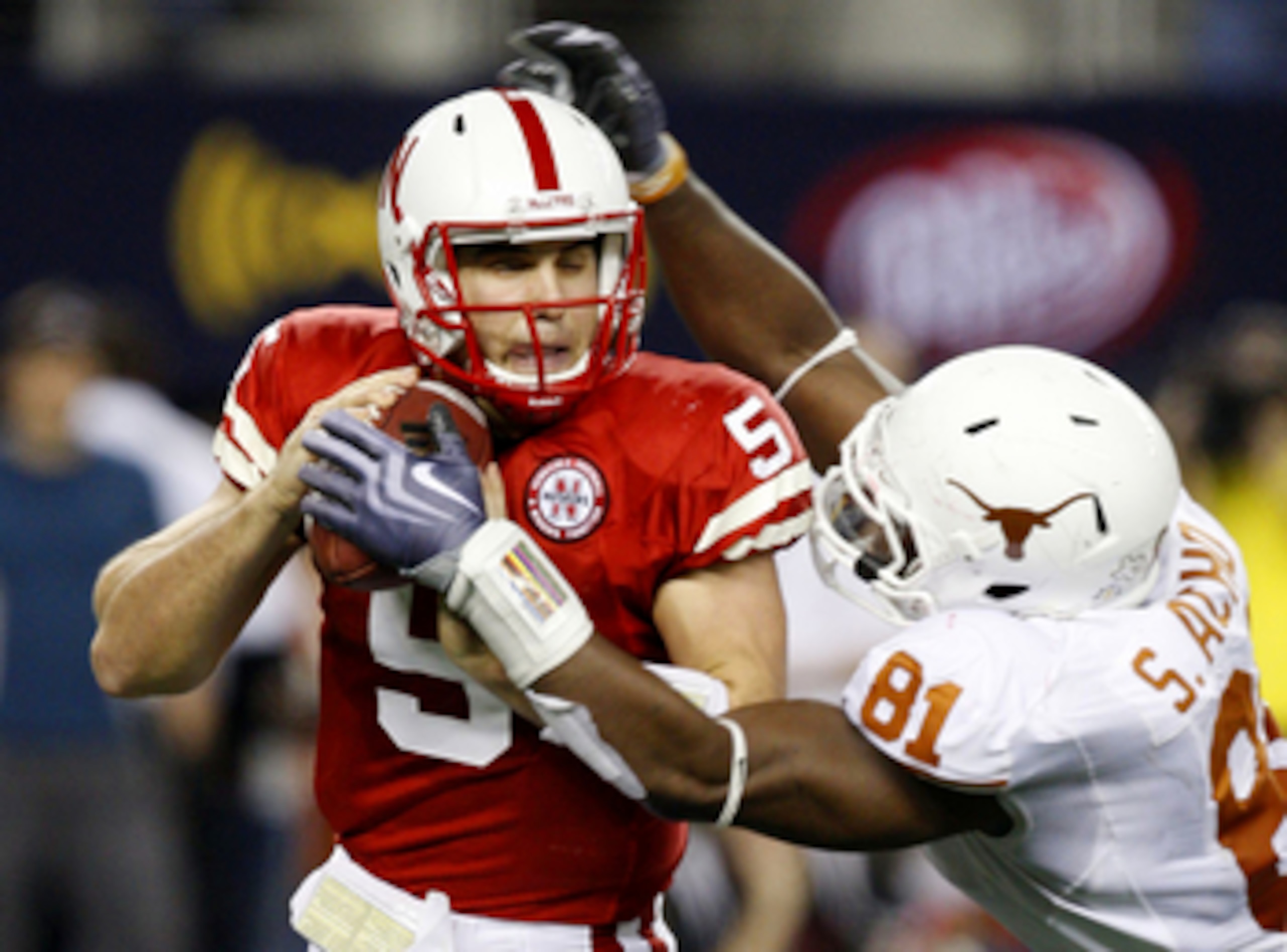 ARLINGTON, TX - DECEMBER 5: Quarterback Zac Lee of the Nebraska Cornhuskers is sacked by Sam Acho #81 of the Texas Longhorns at Cowboys Stadium on December 5, 2009 in Arlington, Texas. (Photo by Ronald Martinez/Getty Images) ARLINGTON, TX - DECEMBER 5: Quarterback Zac Lee of the Nebraska Cornhuskers is sacked by Sam Acho #81 of the Texas Longhorns at Cowboys Stadium on December 5, 2009 in Arlington, Texas. (Photo by Ronald Martinez/Getty Images)