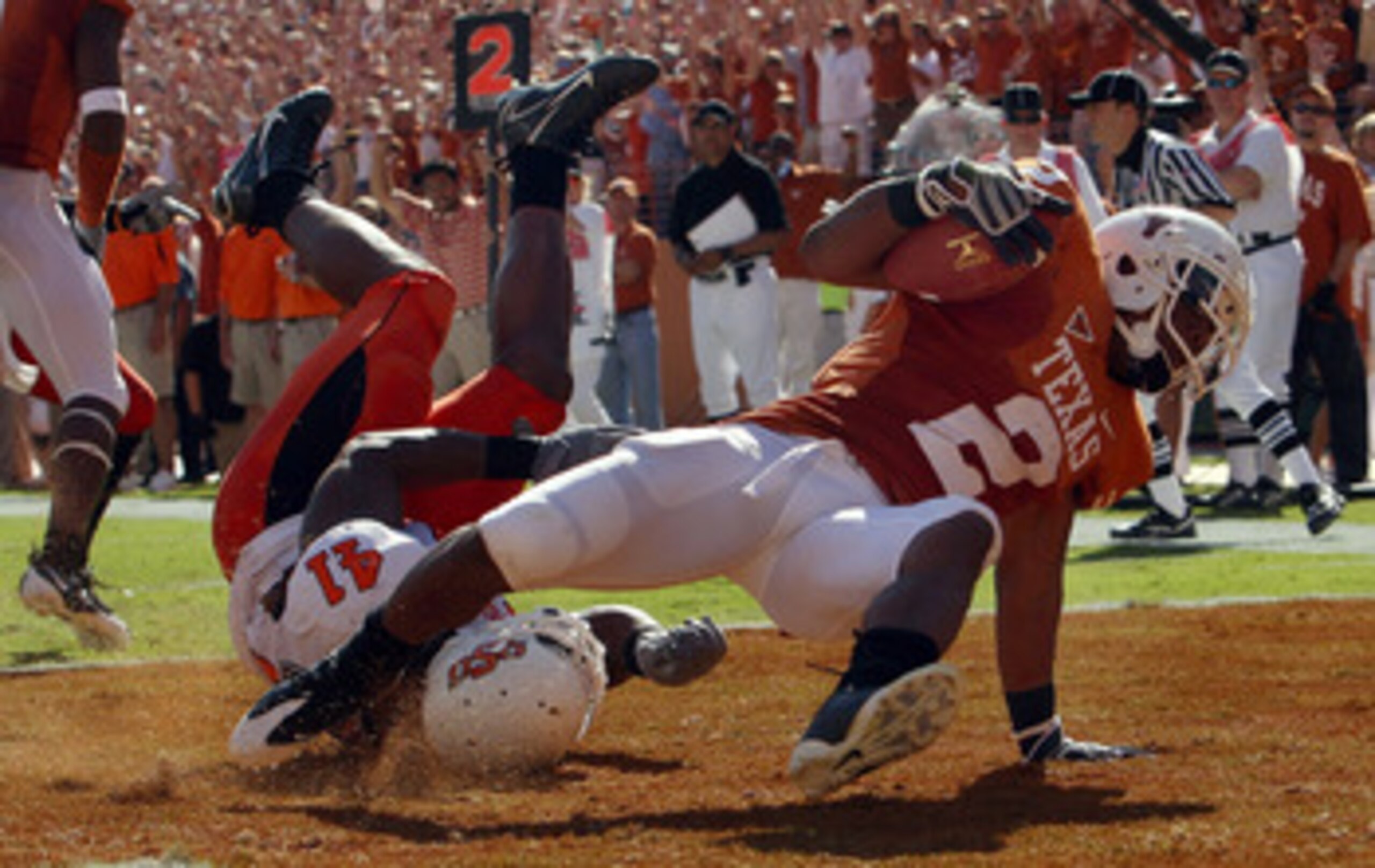 AUSTIN, TX - OCTOBER 25: Running back Vondrell McGee #2 of the Texas Longhorns runs for a touchdown against Orie Lemon #41 of the Oklahoma State Cowboys at Texas Memorial Stadium on October 25, 2008 in Austin, Texas. (Photo by Ronald Martinez/Getty Ima AUSTIN, TX - OCTOBER 25: Running back Vondrell McGee #2 of the Texas Longhorns runs for a touchdown against Orie Lemon #41 of the Oklahoma State Cowboys at Texas Memorial Stadium on October 25, 2008 in Austin, Texas. (Photo by Ronald Martinez/Getty Ima