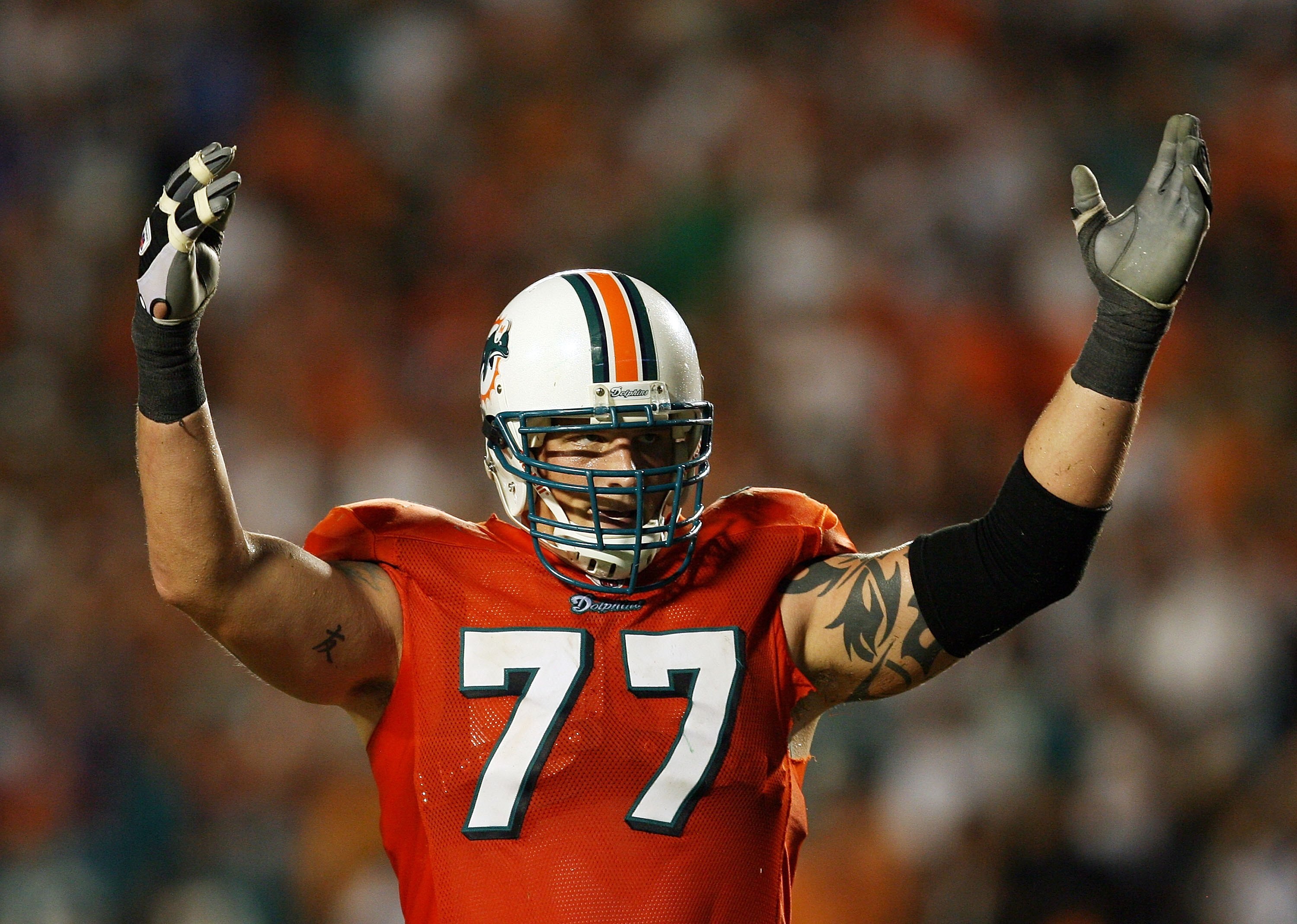MIAMI - OCTOBER 12:  Offensive lineman Jake Long #77 of the Miami Dolphins celebrates after a touchdown by Ronnie Brown #23 against the New York Jets at Land Shark Stadium on October 12, 2009 in Miami, Florida. The Dolphins defeated the Jets 31-27.  (Phot