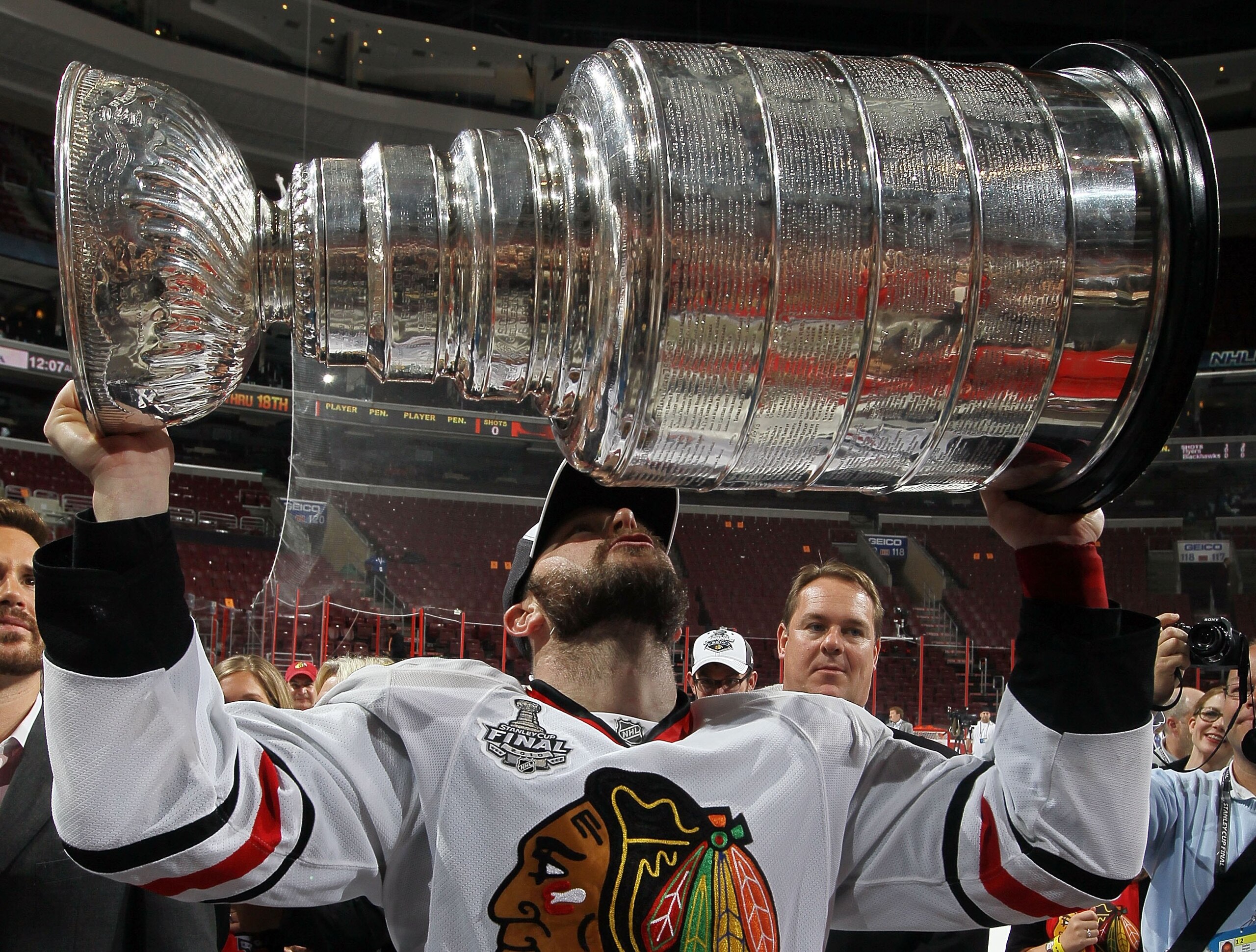 PHILADELPHIA - JUNE 09:  John Madden #11 of the Chicago Blackhawks kisses the Stanley Cup after teammate Patrick Kane scored the game-winning goal in overtime to defeat the Philadelphia Flyers 4-3 and win the Stanley Cup in Game Six of the 2010 NHL Stanle
