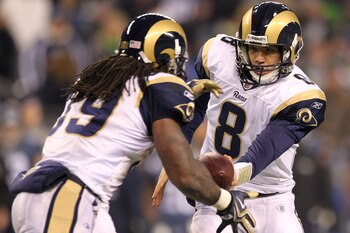 SEATTLE, WA - JANUARY 02:  Quarterback Sam Bradford #8 of the St. Louis Rams hands the ball off to running back Steven Jackson #39 during their game against the Seattle Seahawks at Qwest Field on January 2, 2011 in Seattle, Washington.  (Photo by Otto Gre