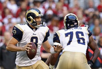 GLENDALE, AZ - DECEMBER 05:  Quarterback Sam Bradford #8 of the St. Louis Rams scrambles to pass the football during the NFL game against the Arizona Cardinals at the University of Phoenix Stadium on December 5, 2010 in Glendale, Arizona. The Rams defeate