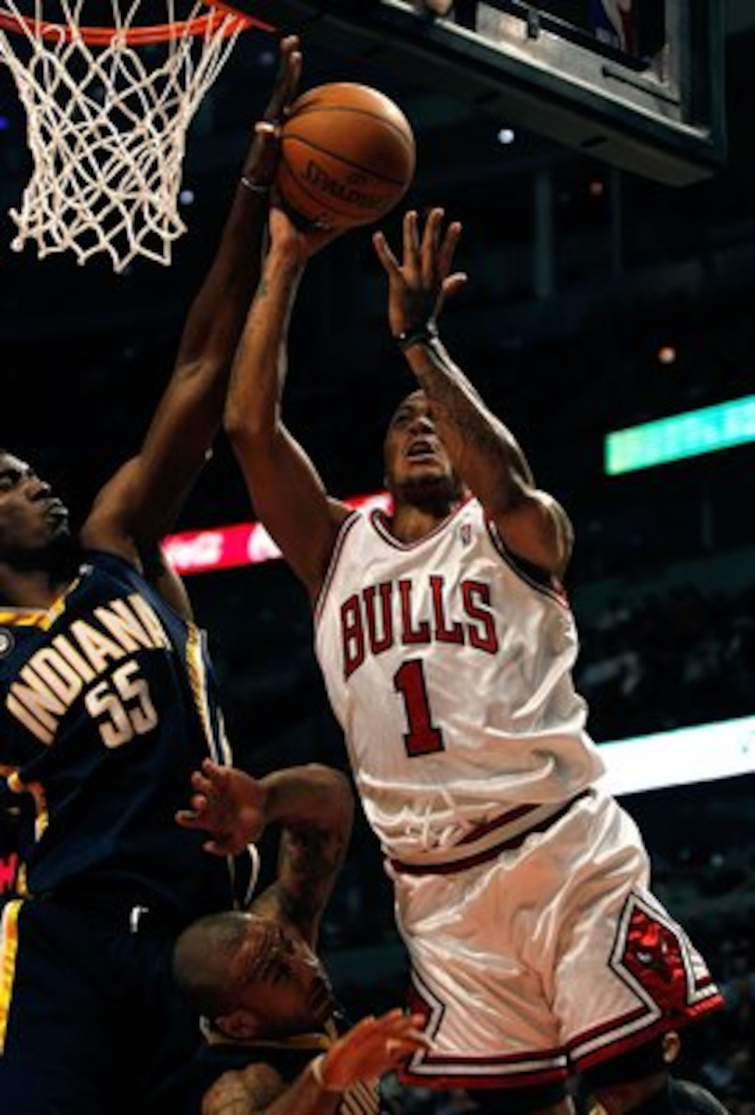 CHICAGO - FEBRUARY 24: Derrick Rose #1 of the Chicago Bulls goes up for a shot against Roy Hibbert #55 and Dahntay Jones #1 of the Indiana Pacers at the United Center on February 24, 2010 in Chicago, Illinois. The Bulls defeated the Pacers 120-110. NOTE T