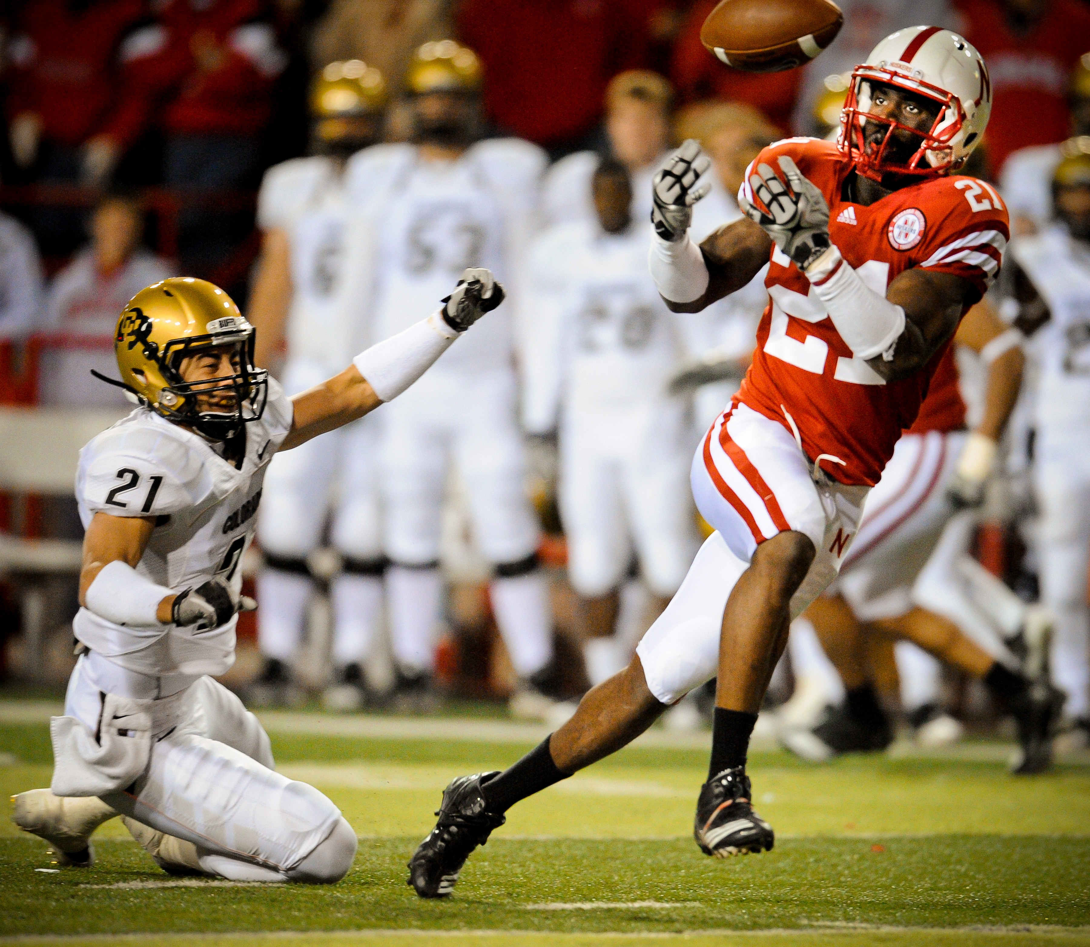 LINCOLN, NE - NOVEMBER 26: Prince Amukamara #21 of the Nebraska Cornhuskers misses a chance at an interception from Scotty McKnight #21 of the Colorado Buffaloes during the second half of their game at Memorial Stadium on November 26, 2010 in Lincoln, Neb