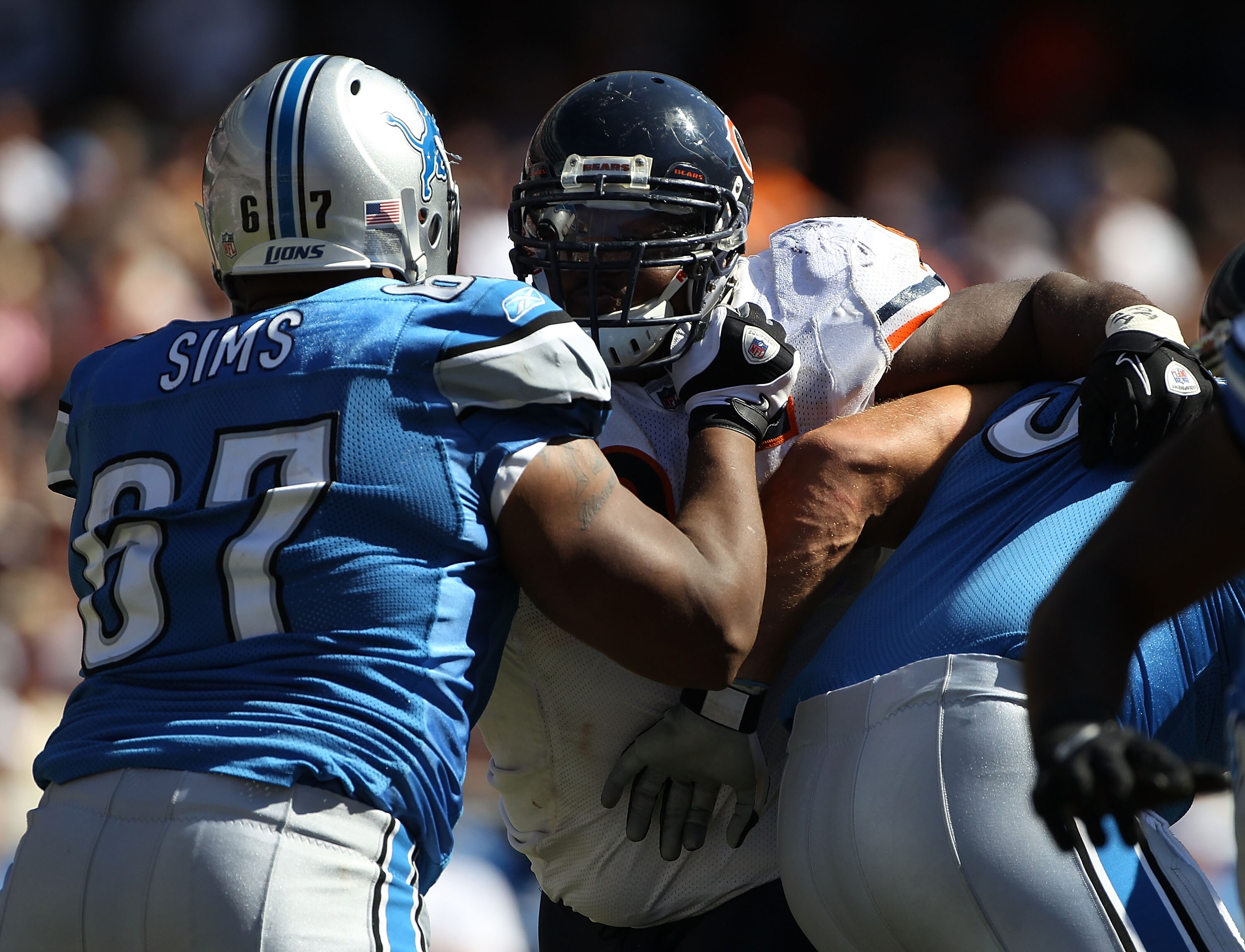 CHICAGO - SEPTEMBER 12: Anthony Adams #95 of the Chicago Bears rushes against Rob Sims #67 and Dominic Raiola #51 of the Detroit Lions during the NFL season opening game at Soldier Field on September 12, 2010 in Chicago, Illinois. The Bears defeated the L
