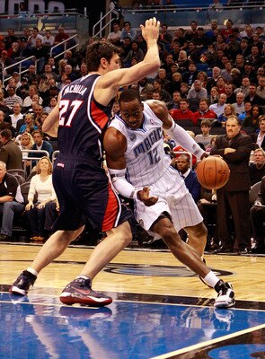 ORLANDO, FL - DECEMBER 06:  Dwight Howard #12 of the Orlando Magic drives against Zaza Pachulia #27 of the Atlanta Hawks during the game at Amway Arena on December 6, 2010 in Orlando, Florida. NOTE TO USER: User expressly acknowledges and agrees that, by 