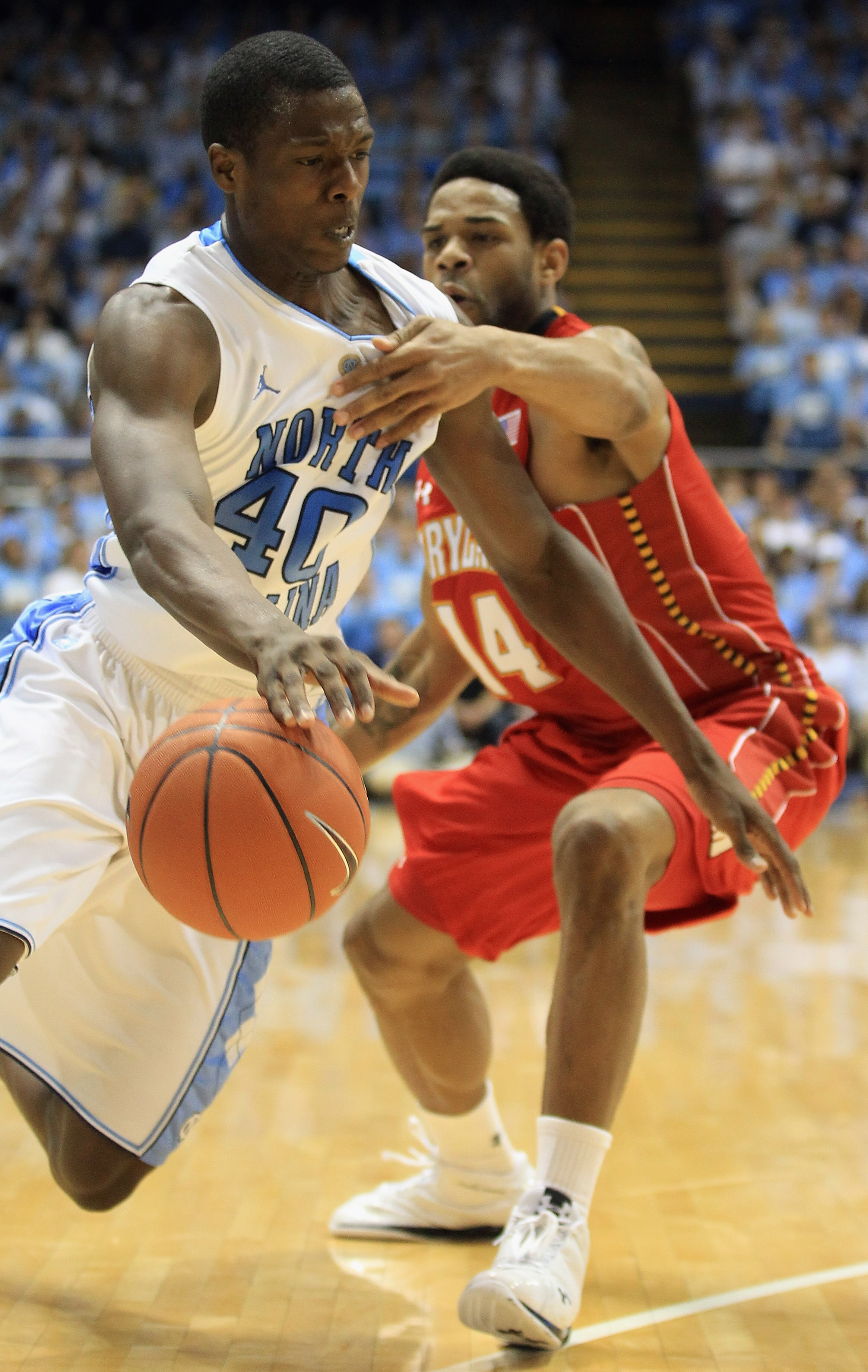 CHAPEL HILL, NC - FEBRUARY 27:  Sean Mosley #14 of the Maryland Terrapins fouls Harrison Barnes #40 of the North Carolina Tar Heels on his drive to the basket during their game at the Dean E. Smith Center on February 27, 2011 in Chapel Hill, North Carolin