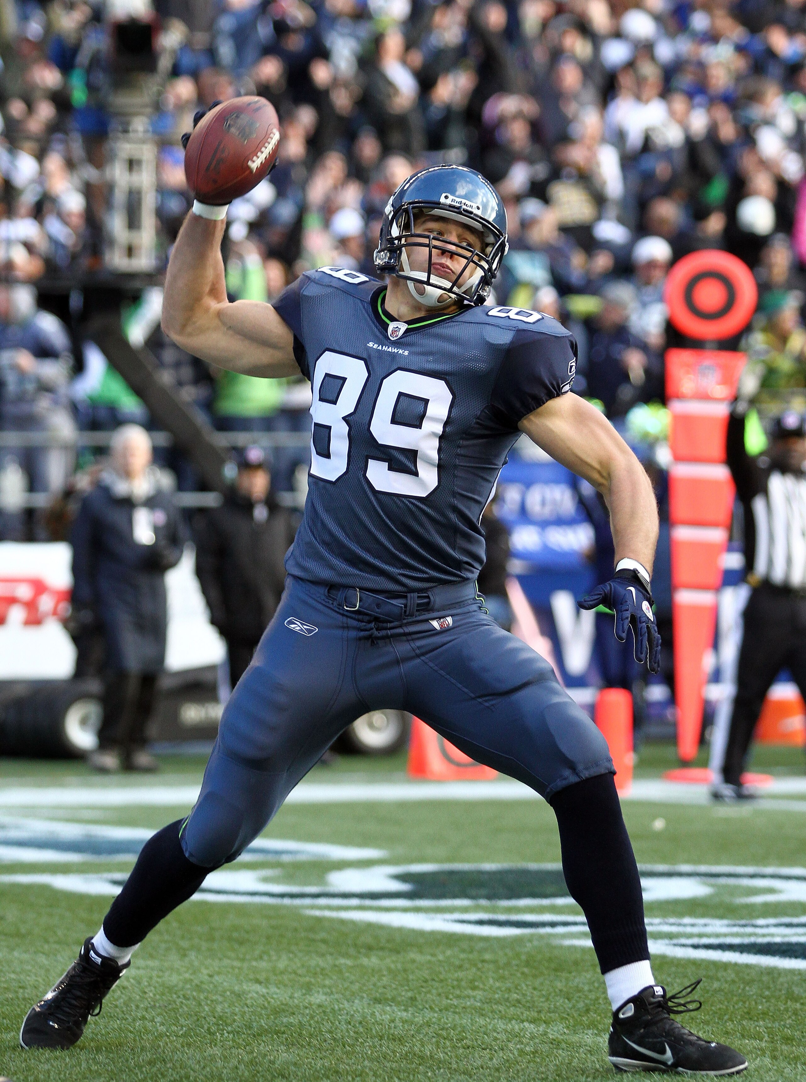 SEATTLE, WA - JANUARY 08:  Tight end John Carlson #89 of the Seattle Seahawks celebrates his 11-yard touchdown reception in the first quarter against the New Orleans Saints during the 2011 NFC wild-card playoff game at Qwest Field on January 8, 2011 in Se